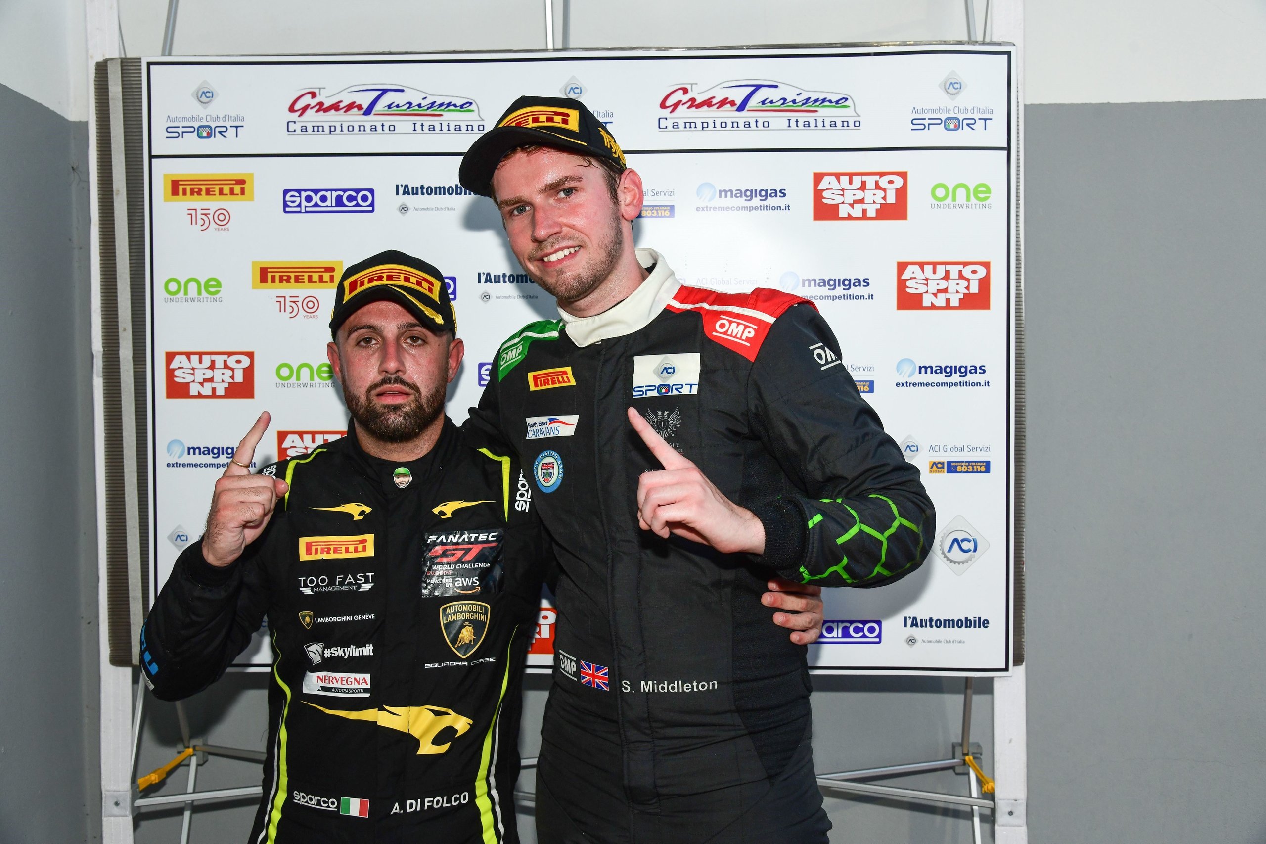 How Imperiale Racing'S Eight-Tenths-Of-A-Second Imola Win Proved The Huracán Gt3 Evo Still Bites 5 Winning drivers alberto di folco and stuart middleton posing in racing suits in front of sponsor board after the imola race