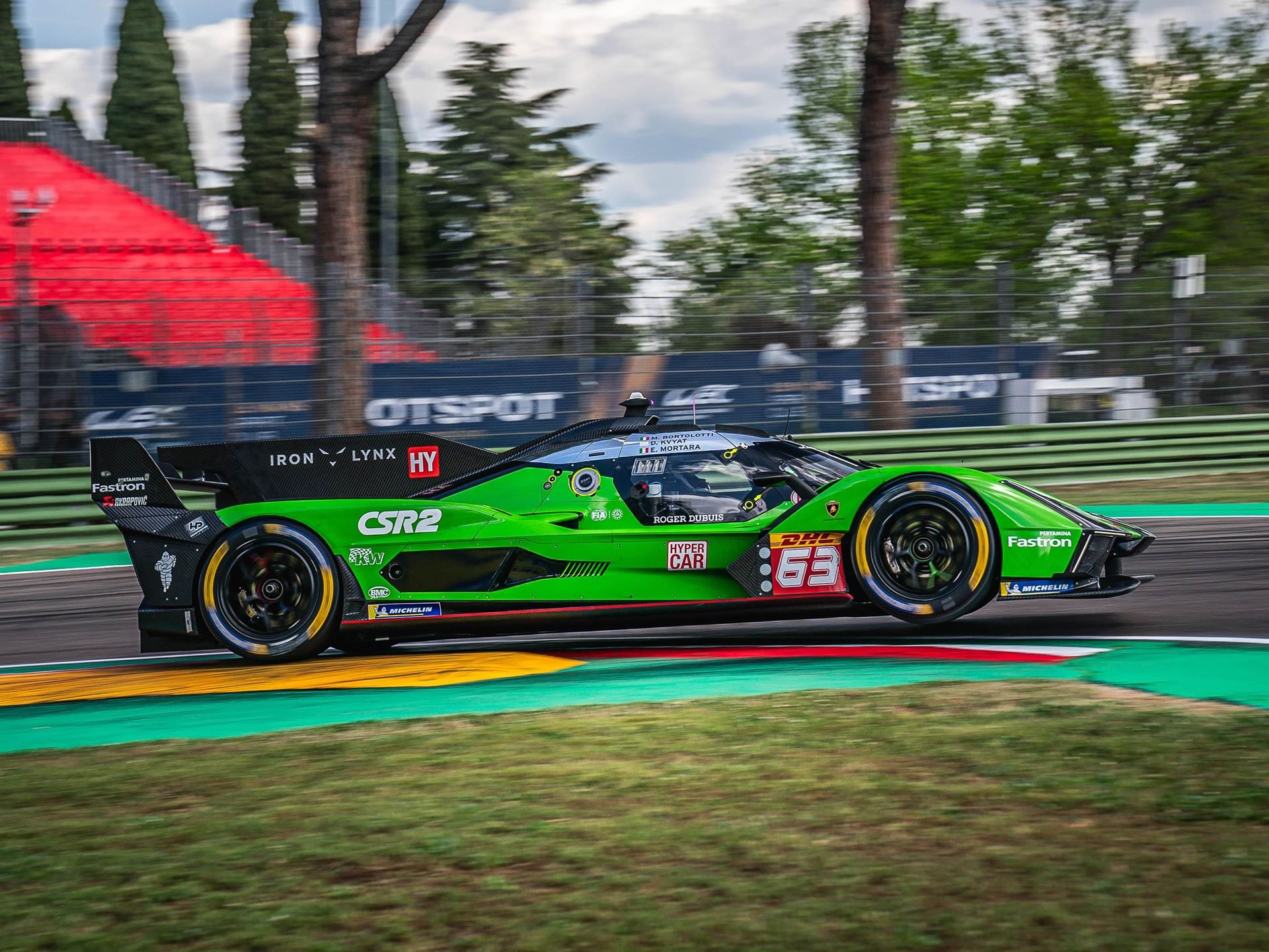 Lamborghini Iron Lynx Brings Track Knowledge And Unchanged Crew To Cota After Bruising Brazil Round 5 Lamborghini sc63 hypercar speeding through a corner with colorful curbing visible