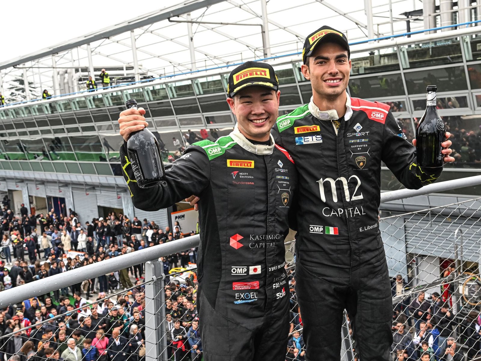 Edoardo Liberati and Yuki Nemoto celebrate on the podium after winning the Italian GT Championship Endurance Cup at Monza