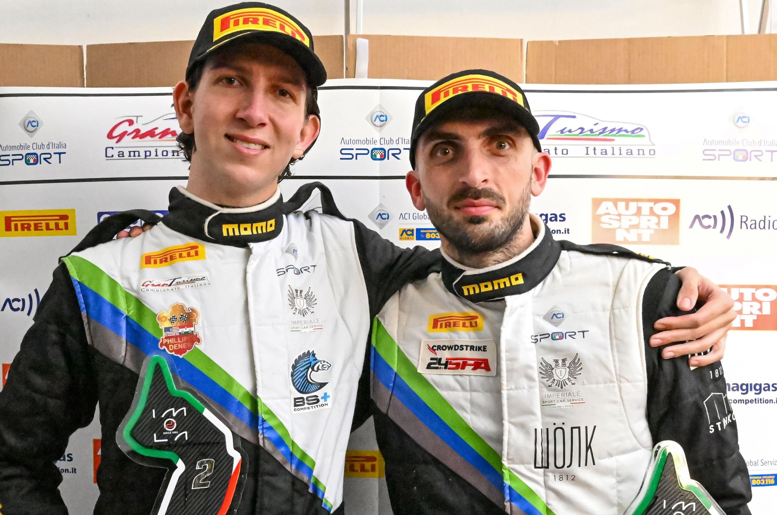 Lamborghini Swept Every Race At Imola And Still Lost The Italian Gt Sprint Title On Countback 7 Two lamborghini racing drivers in team suits smiling against a sponsor backdrop at the italian gt championship sprint cup finale