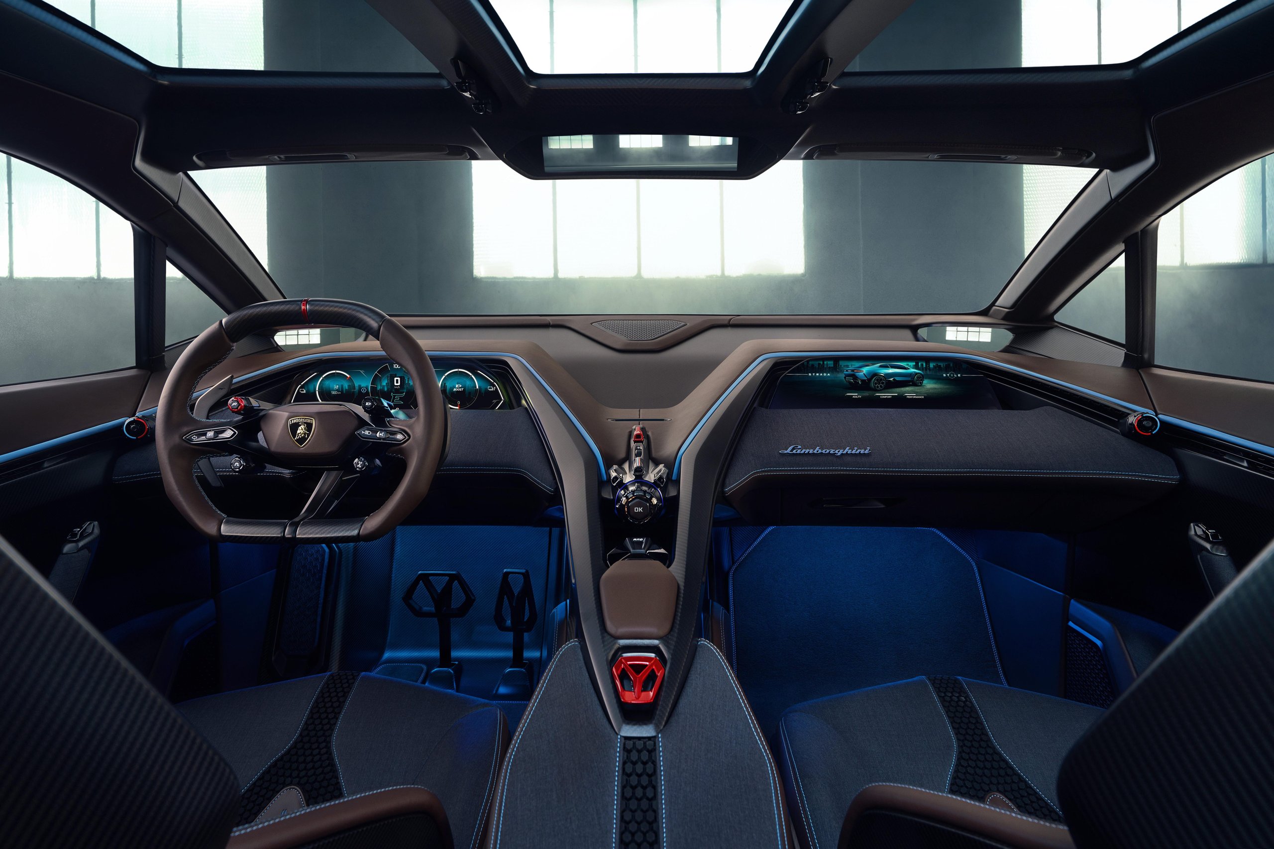 Lamborghini Lanzador: The 'Ultra Gt' That Went From Electric Manifesto To Hybrid Reality 9 Symmetrical interior view of the lanzador concept showing steering wheel, dual digital displays, floating center console, and ambient blue lighting