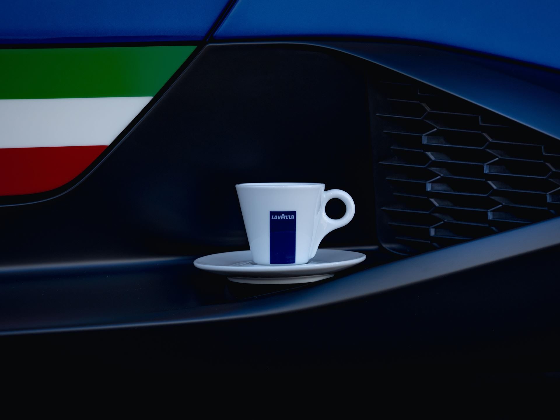 Lamborghini Partners With Lavazza To Pour Italian Luxury Beyond The Showroom 7 White lavazza espresso cup placed on the side vent of a blue lamborghini with an italian flag stripe