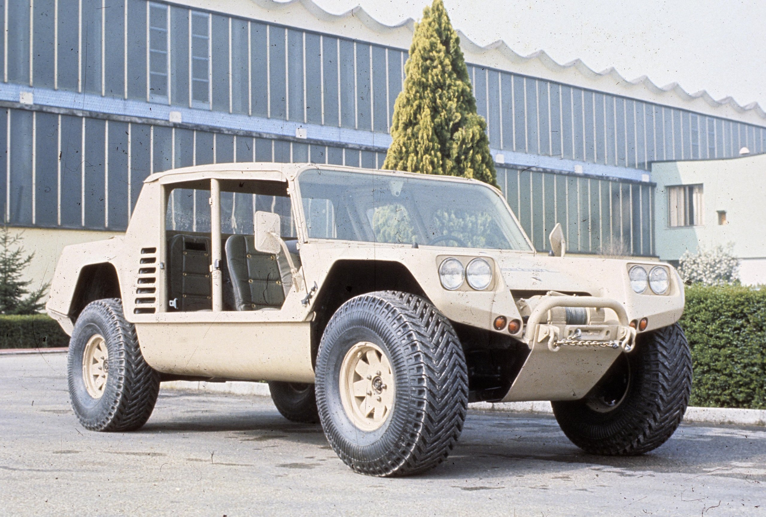The 'Rambo Lambo' At 40: How Lamborghini'S V12 Off-Roader Invented The Super Suv And Paved The Road To The Urus 3 Lamborghini cheetah prototype in desert tan color parked on asphalt