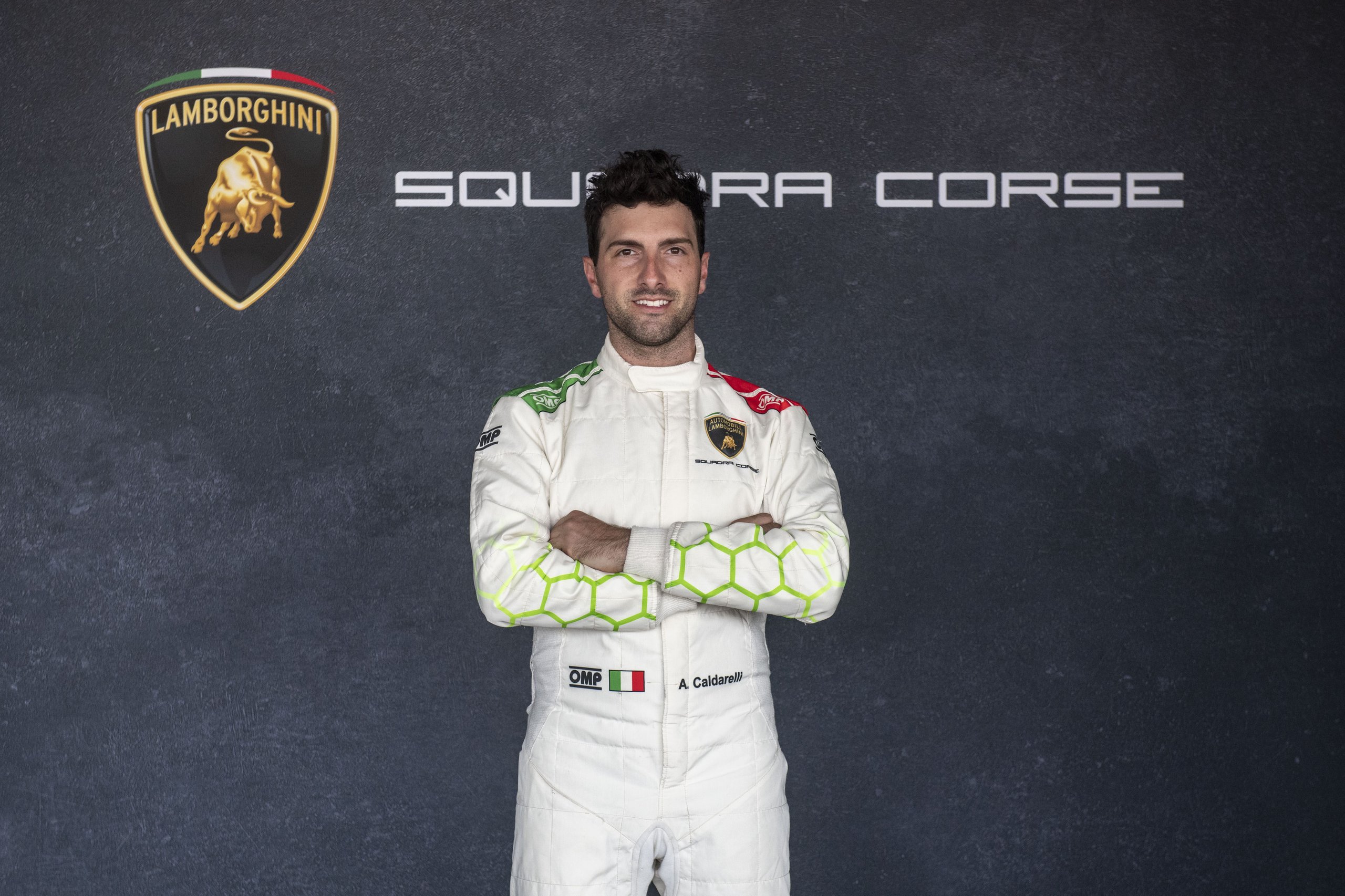 Caldarelli And Bortolotti: Why Lamborghini Built Its Lmdh Program On Gt Loyalty 5 Andrea caldarelli in lamborghini squadra corse white racing suit with green and red accents, arms crossed, against a dark background with squadra corse branding