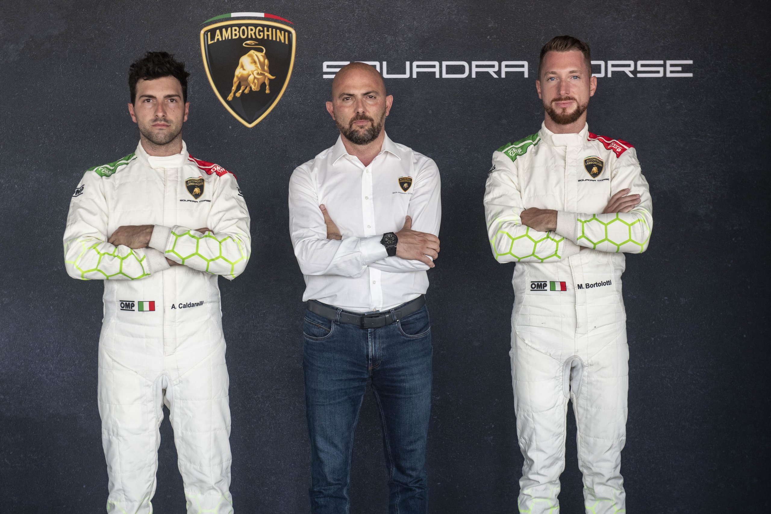 Caldarelli And Bortolotti: Why Lamborghini Built Its Lmdh Program On Gt Loyalty 7 Andrea caldarelli, mirko bortolotti in racing suits, and a third team official in white shirt, standing arms crossed against a dark background with lamborghini and squadra corse logos
