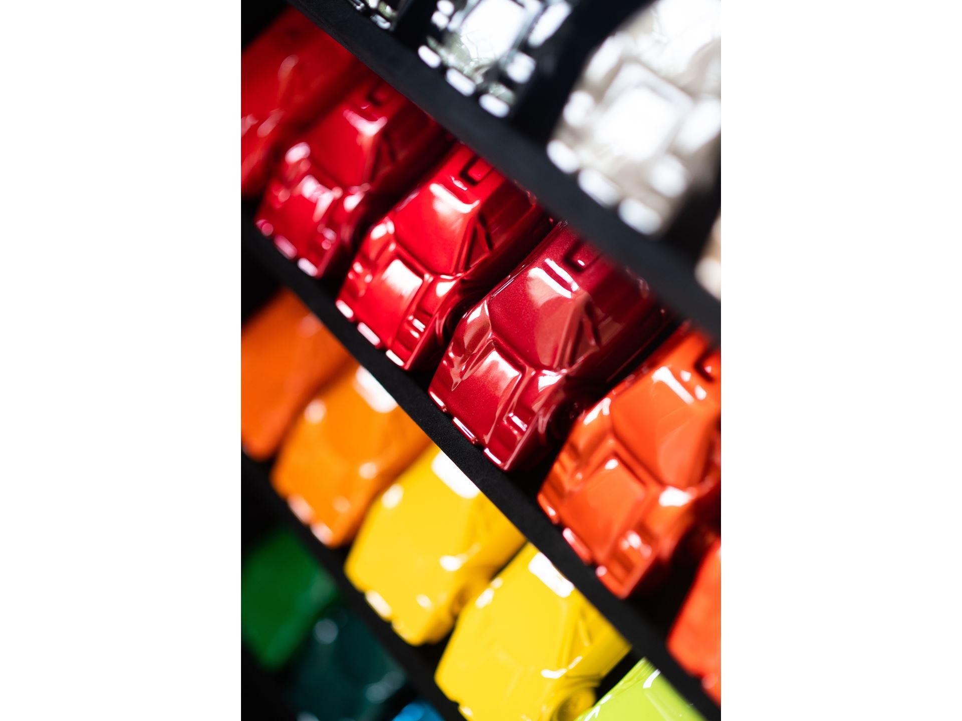 Inside Lamborghini'S Pebble Beach Playbook: How The Lounge Monterey Sells A Lifestyle, Not Just Supercars 9 Close-up of lamborghini paint samples in vibrant colors displayed on shelves at the ad personam studio