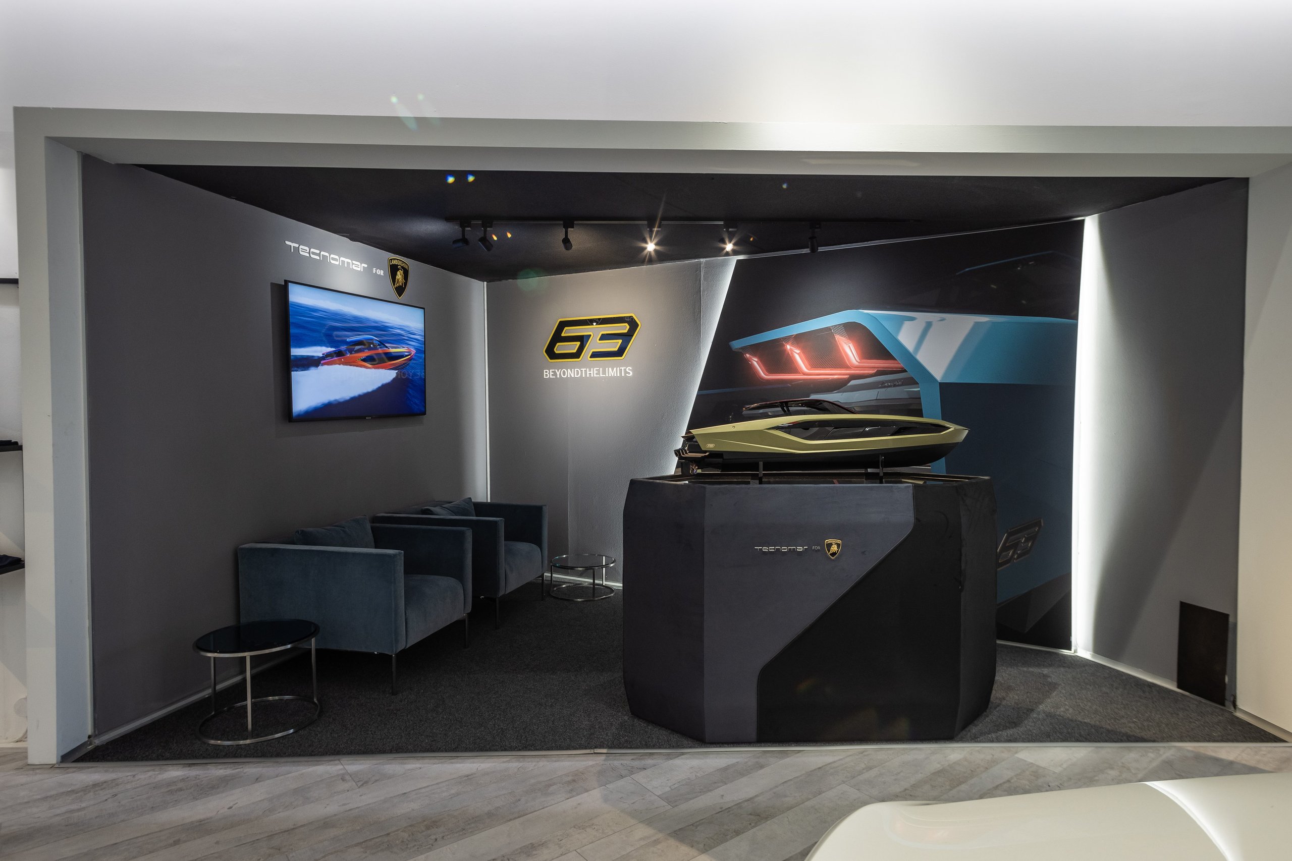 Porto Cervo'S Lamborghini Lounge: Where Ad Personam Meets The Sardinian Coast 7 Exhibition area for the tecnomar for lamborghini 63 yacht inside the porto cervo lamborghini lounge with model yacht and display screen