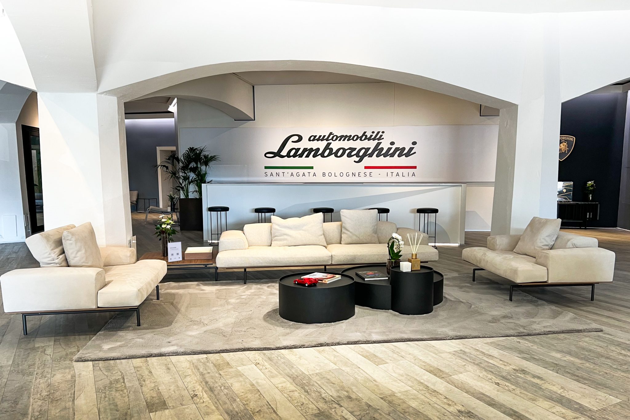 Lamborghini'S Porto Cervo Pop-Up Is A Masterclass In Selling The Supercar Life, Not Just Supercars 5 Cream sofas and coffee tables in the lamborghini lounge porto cervo hospitality area with automobili lamborghini signage