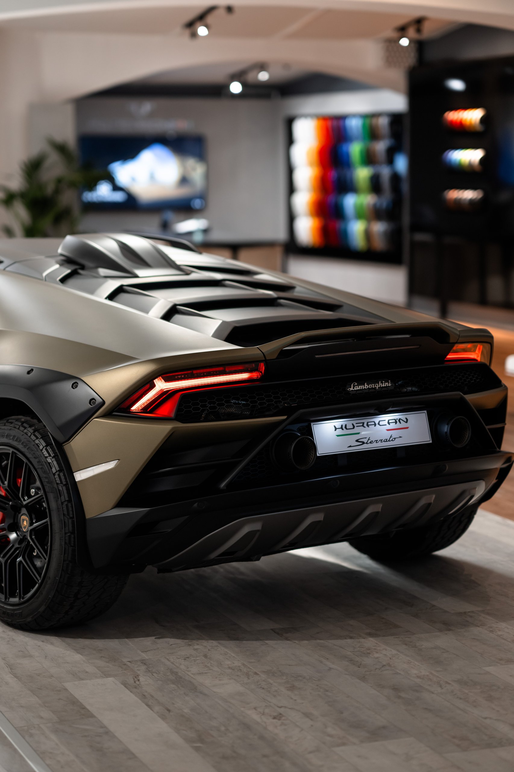 Inside Lamborghini'S Porto Cervo Lounge, Where The Revuelto Meets Its Future Owners 7 Rear three-quarter view of matte gold huracán sterrato in the porto cervo showroom highlighting fender flares and off-road design