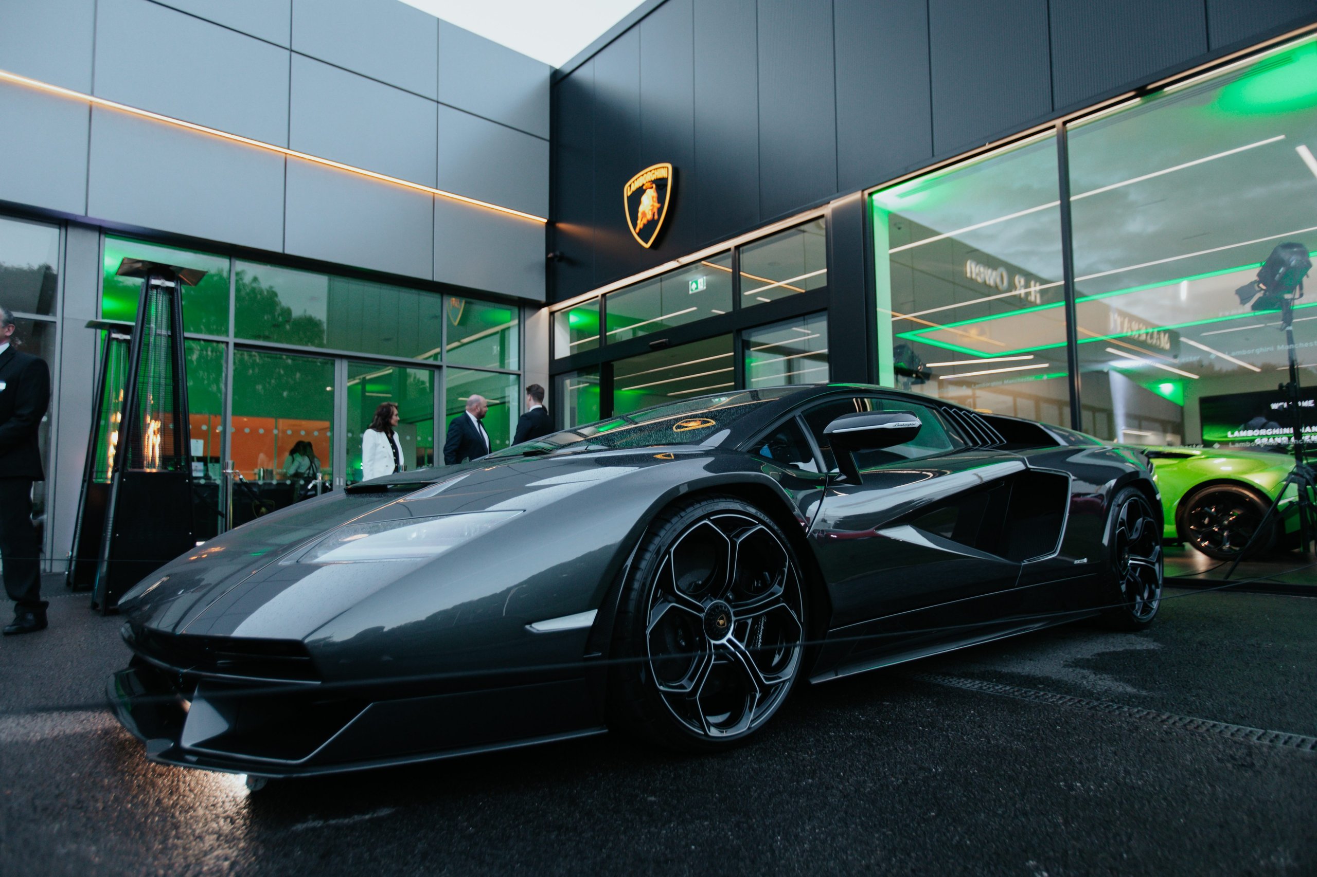Lamborghini Manchester'S New Stockport Showroom Signals Where The Brand Is Placing Its Uk Bets 7 Grey lamborghini countach lpi 800-4 parked outside the lamborghini manchester showroom at night with green ambient lighting visible inside