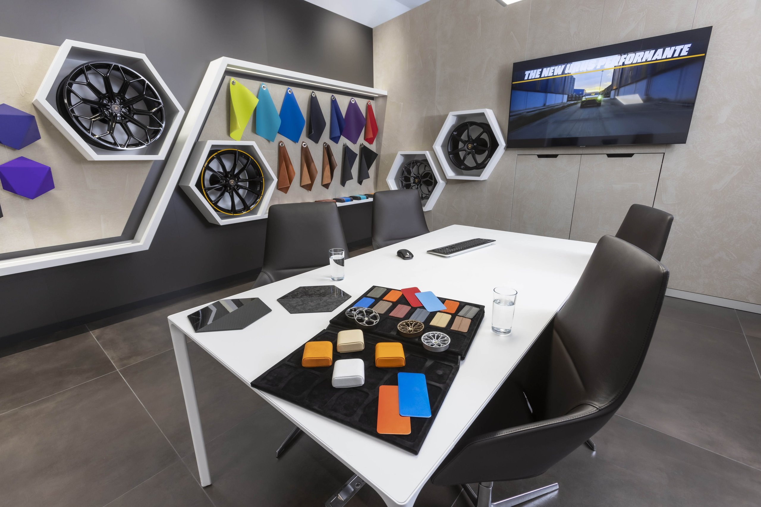 Lamborghini Manchester'S New Stockport Showroom Signals Where The Brand Is Placing Its Uk Bets 5 Interior of the lamborghini manchester ad personam consultation room with material samples, wheel displays, and a large configuration screen