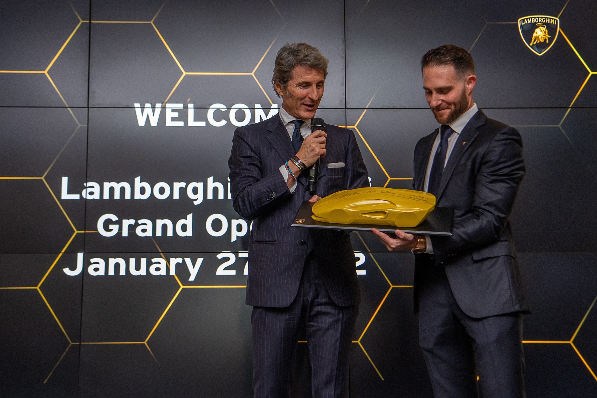 Lamborghini Miami'S Showroom Overhaul Reveals What The Brand'S Retail Future Looks Like 5 Stephan winkelmann speaking at the lamborghini miami grand opening event with welcome screen visible