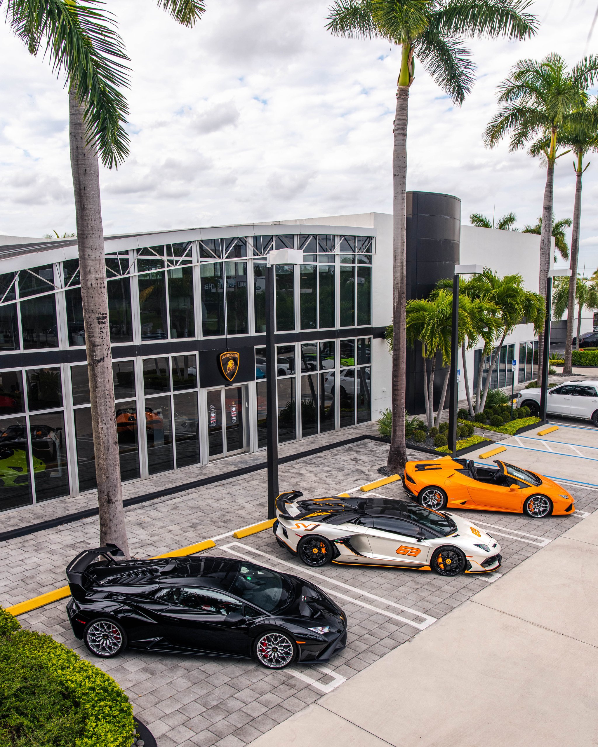 Lamborghini Miami'S Showroom Overhaul Reveals What The Brand'S Retail Future Looks Like 3 Aerial view of the remodeled lamborghini miami showroom exterior with aventador, aventador svj, and huracan parked in front