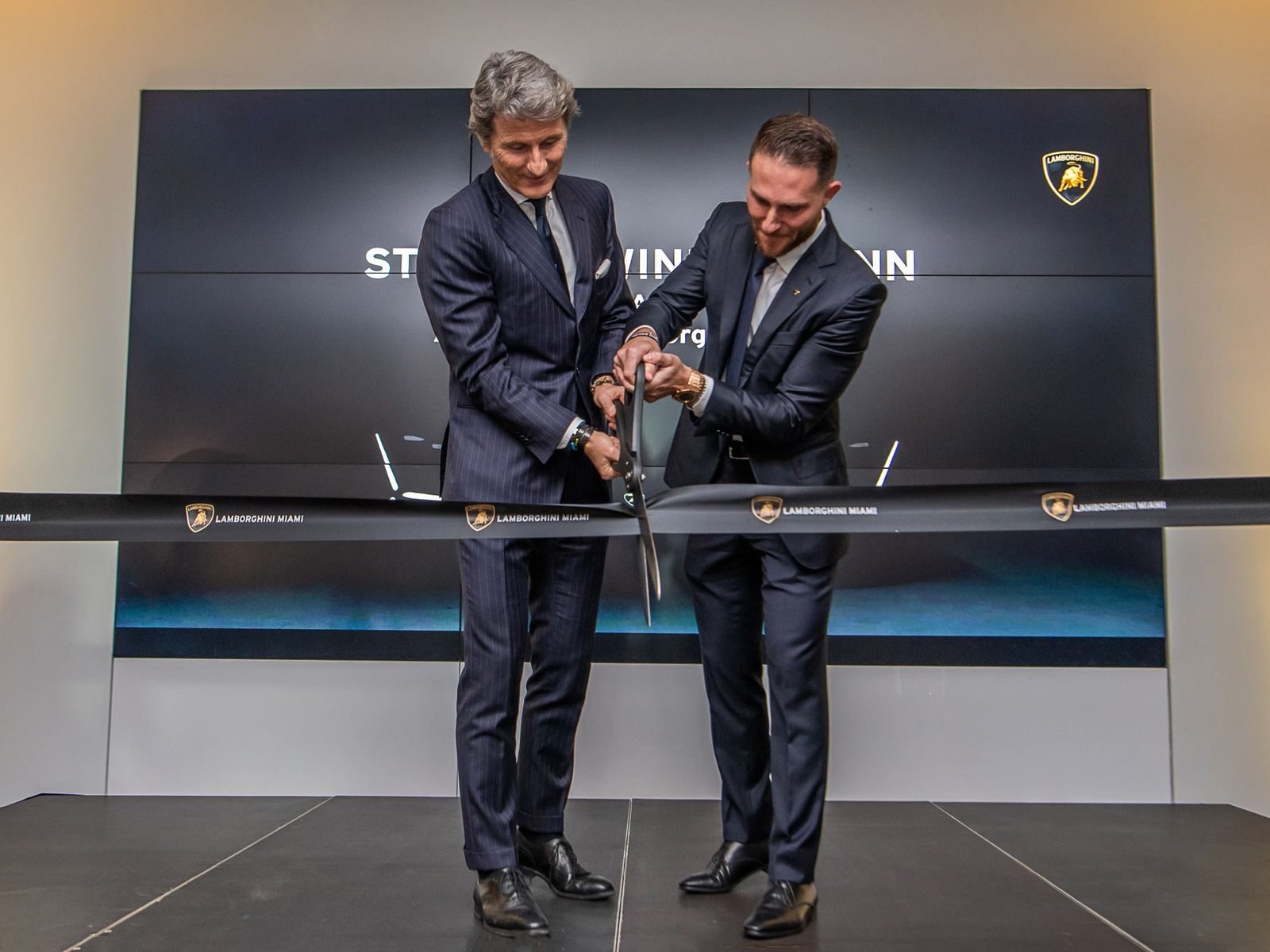 Stephan Winkelmann and Brett David cut the ribbon at the Lamborghini Miami grand reopening event