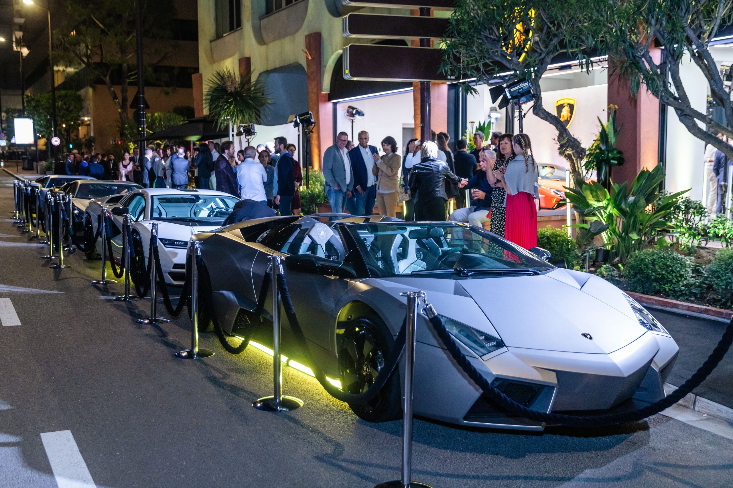 Lamborghini Monaco: How A 218-Square-Meter Showroom Became The Brand'S Riviera Calling Card 7 Line of lamborghini supercars including a murciélago and aventador ultimae parked on a monaco street at night near the illuminated showroom