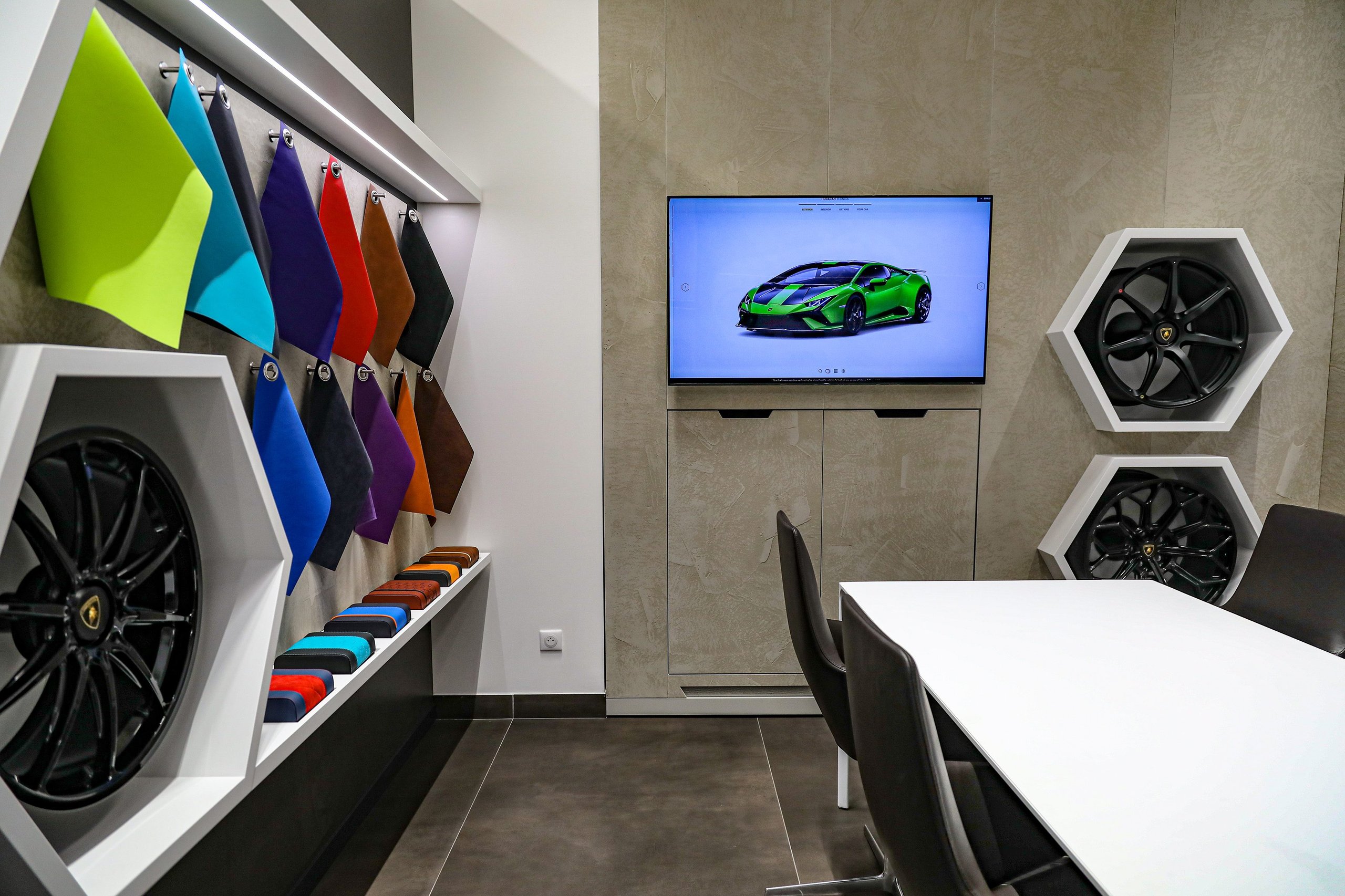 Lamborghini Monaco: How A 218-Square-Meter Showroom Became The Brand'S Riviera Calling Card 5 Lamborghini ad personam studio in monaco showing colorful material swatches, display wheels, and a configurator screen with a green huracan