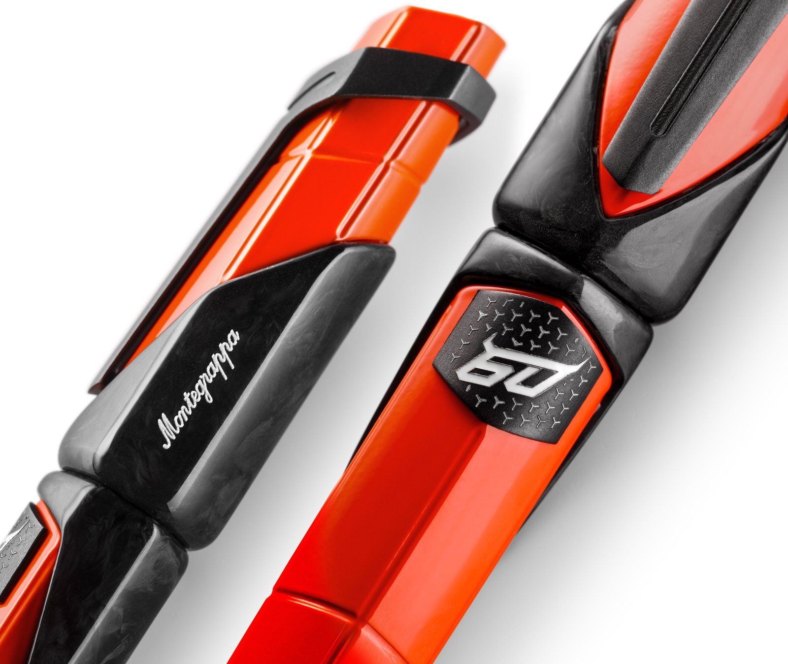 Two Montegrappa Automobili Lamborghini 60th Anniversary pens in Arancio Apodis orange and Nero Noctis black, showing hexagonal profile and 60th anniversary emblem