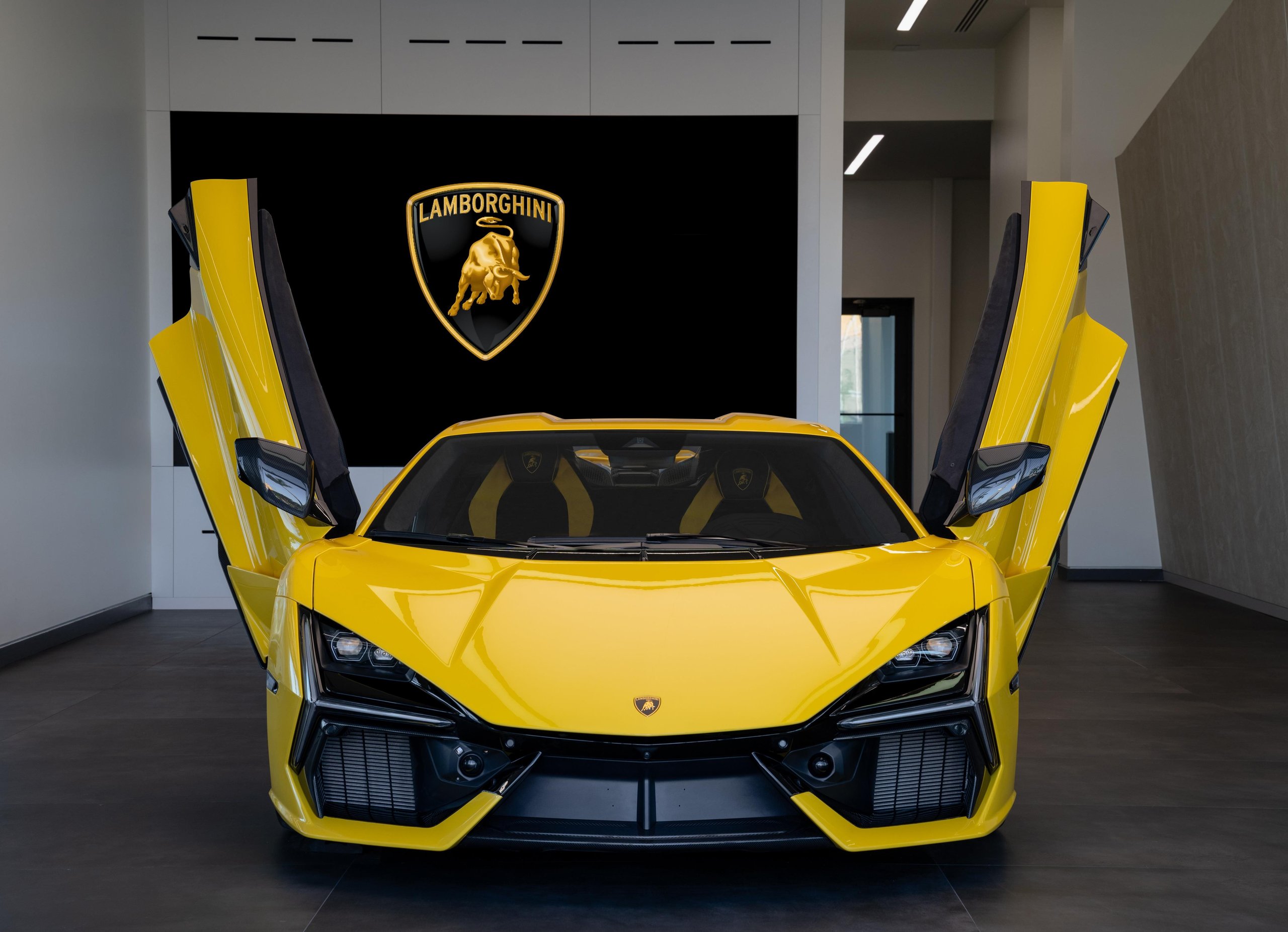 Lamborghini Naples: Why Florida'S Sixth Showroom Tells A Bigger Story About The Brand'S Us Ambitions 5 Front view of a yellow lamborghini revuelto with scissor doors open inside the naples showroom