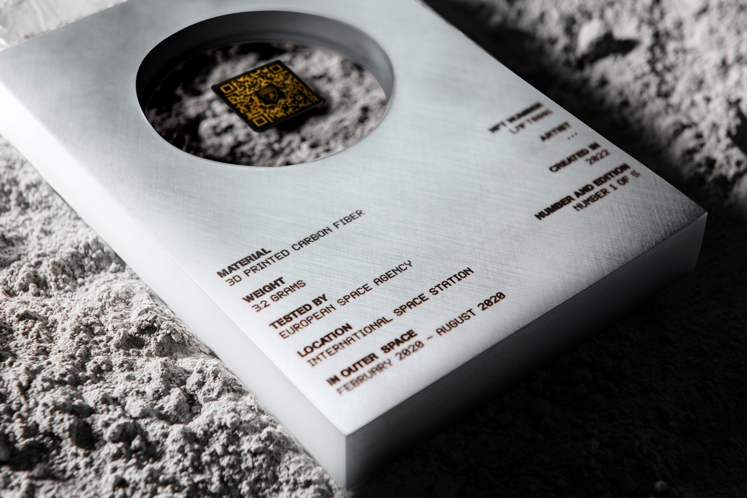 Lamborghini'S Space Key Nft Pairs Iss-Flown Carbon Fiber With Digital Art In A Five-Unit Collector'S Gambit 3 Close-up of lamborghini space key showing engraved details: 3d printed carbon fiber, 3. 2 grams, tested by european space agency, iss, feb-aug 2020