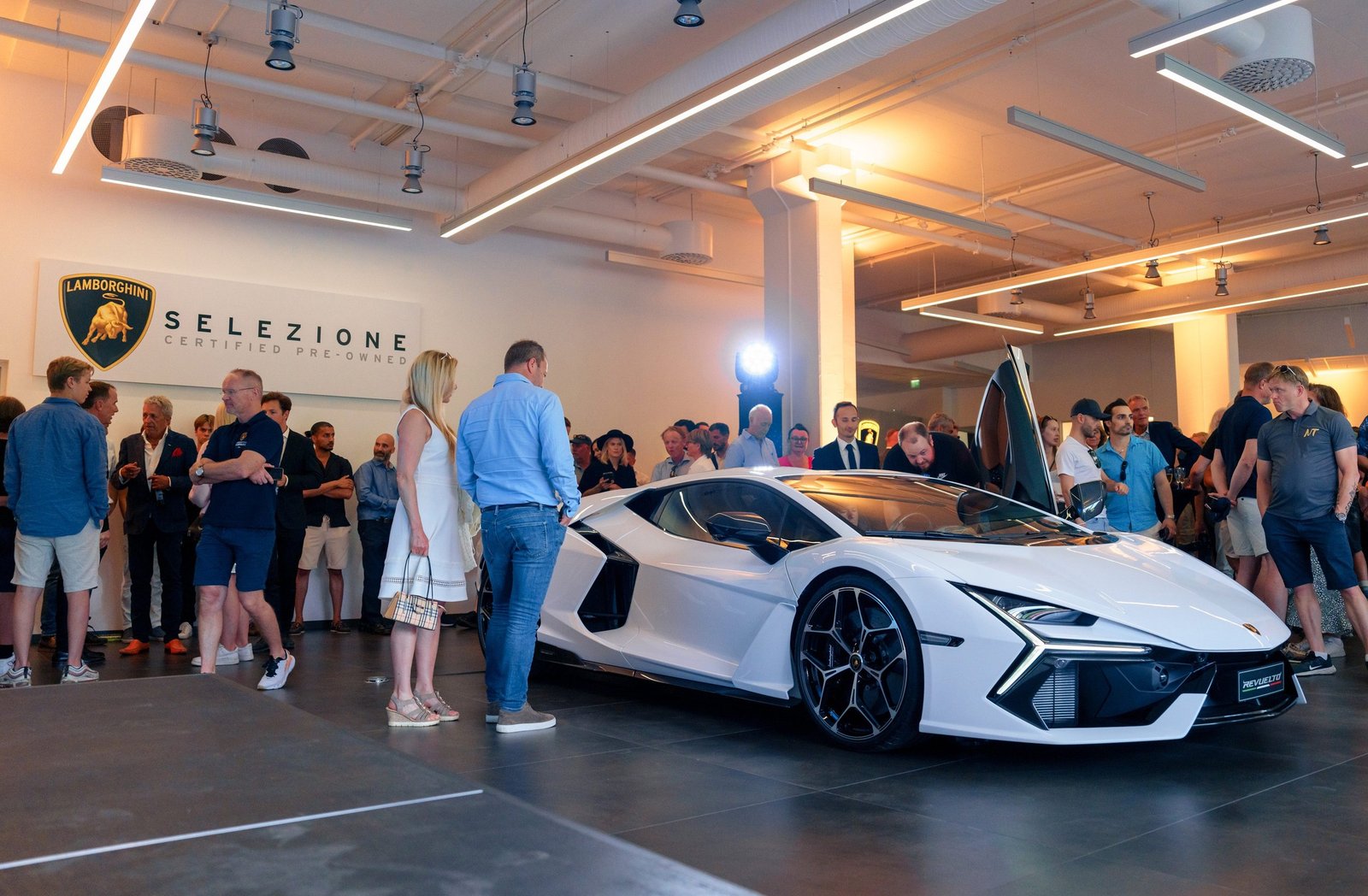 White Lamborghini Sián FKP 37 displayed at the Lamborghini Oslo grand opening event with guests admiring the hypercar