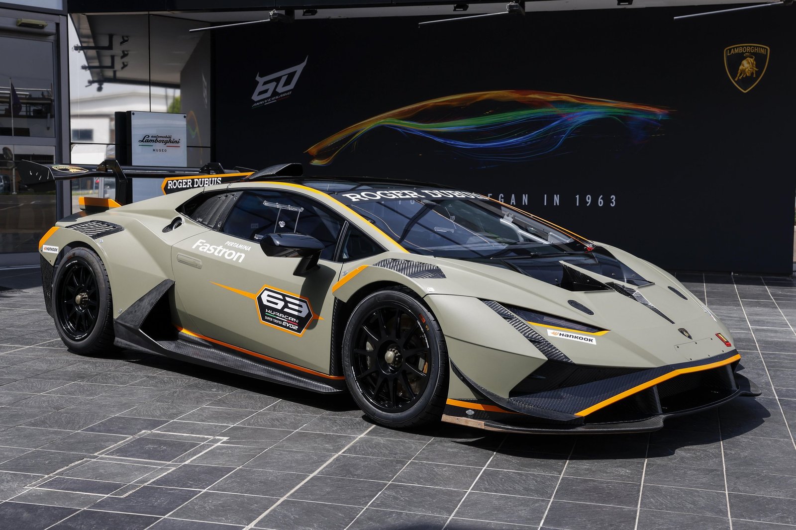 Lamborghini Huracan Super Trofeo EVO2 in matte green with orange accents and 60th Anniversary backdrop