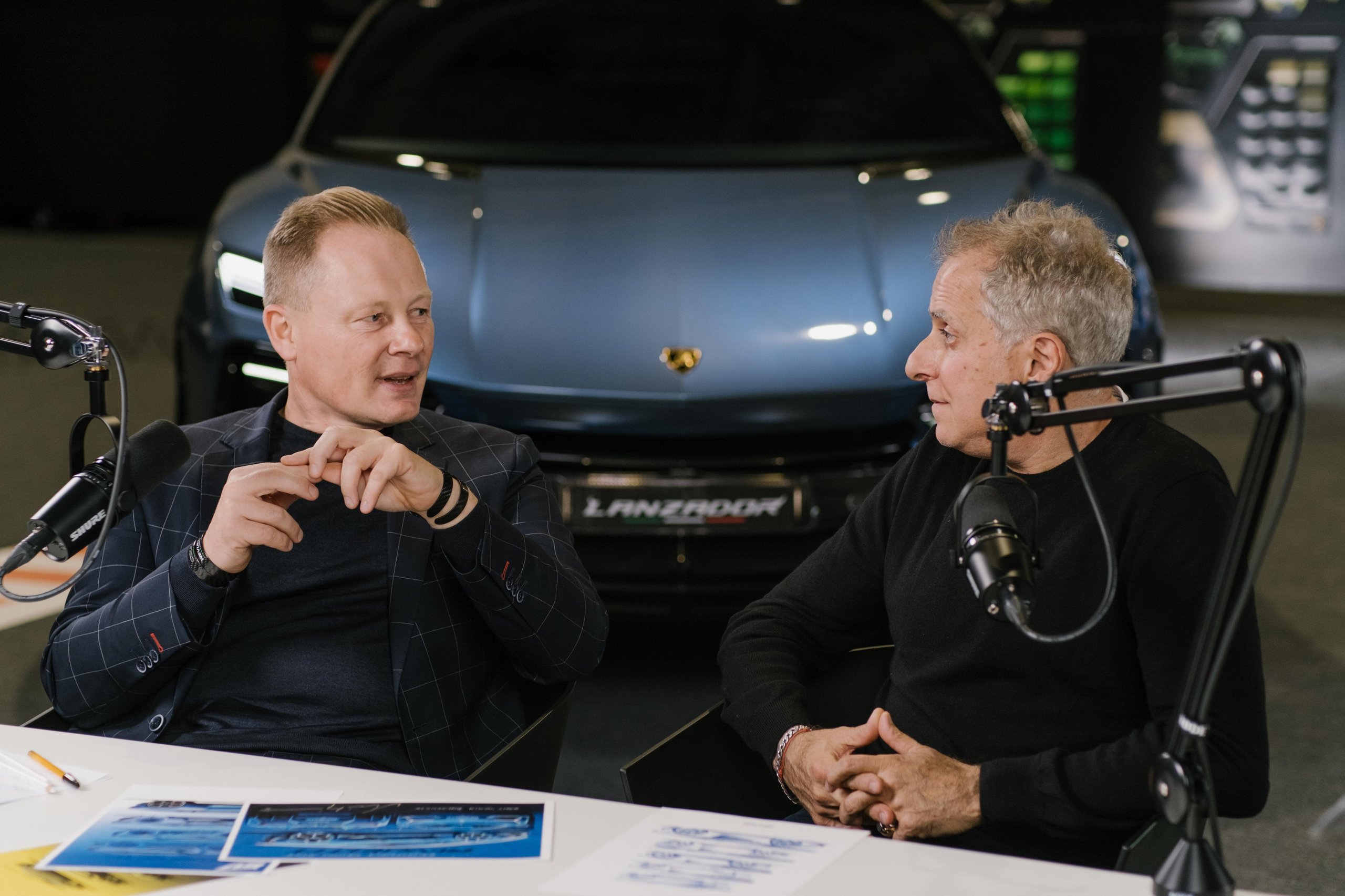 Lamborghini'S Design Chief Reveals How Depeche Mode And Vinyl Sleeves Shaped The Cars You Want To Buy 5 Mitja borkert in animated conversation at the podcast table with the lamborghini lanzador concept visible behind him