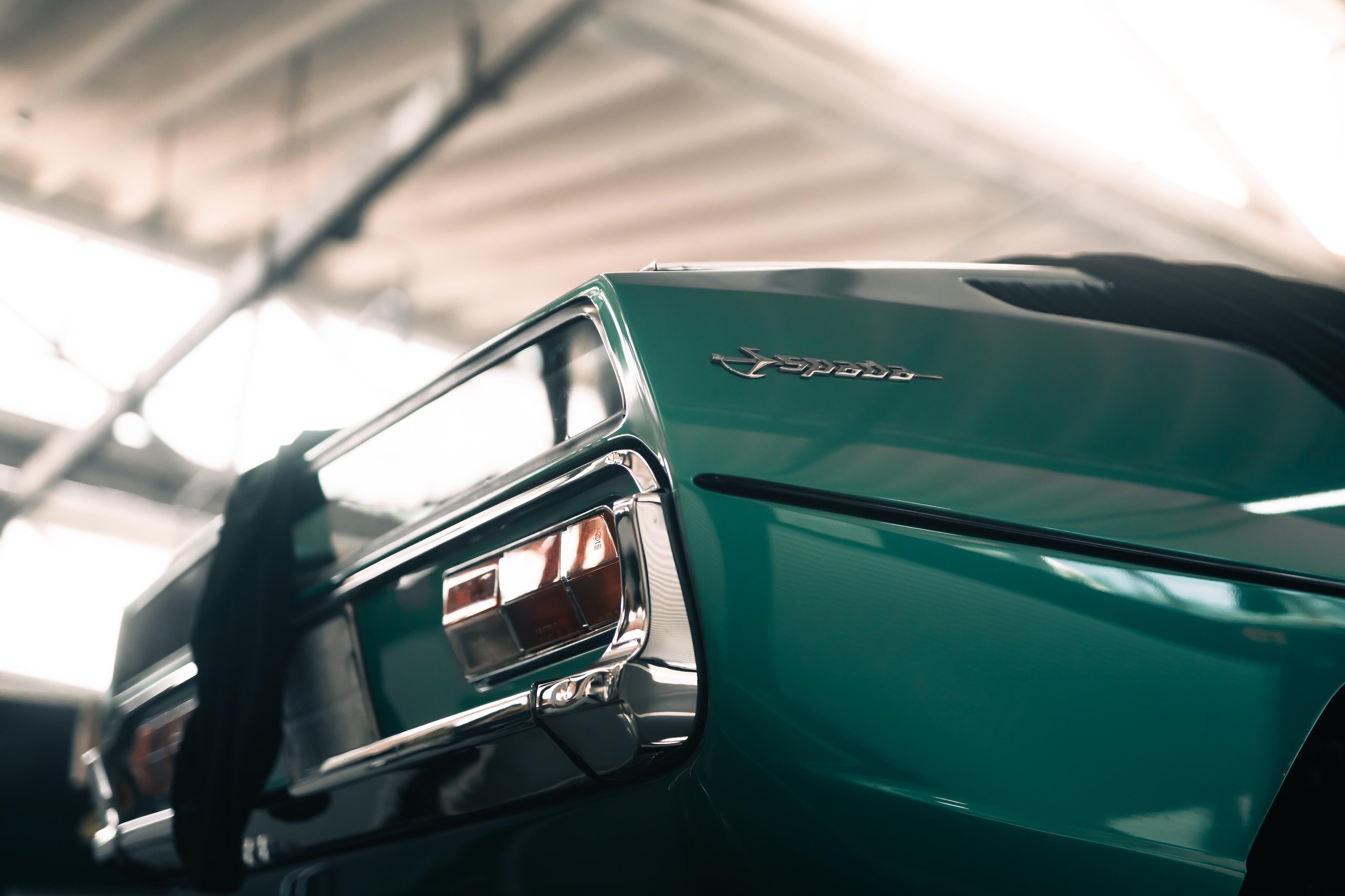 Polo Storico At Ten: Why Lamborghini Let Collectors Get Their Hands Dirty In Sant'Agata 9 Close-up of the rear quarter of a teal lamborghini islero showing taillights, chrome bumper, and islero badge in the polo storico workshop