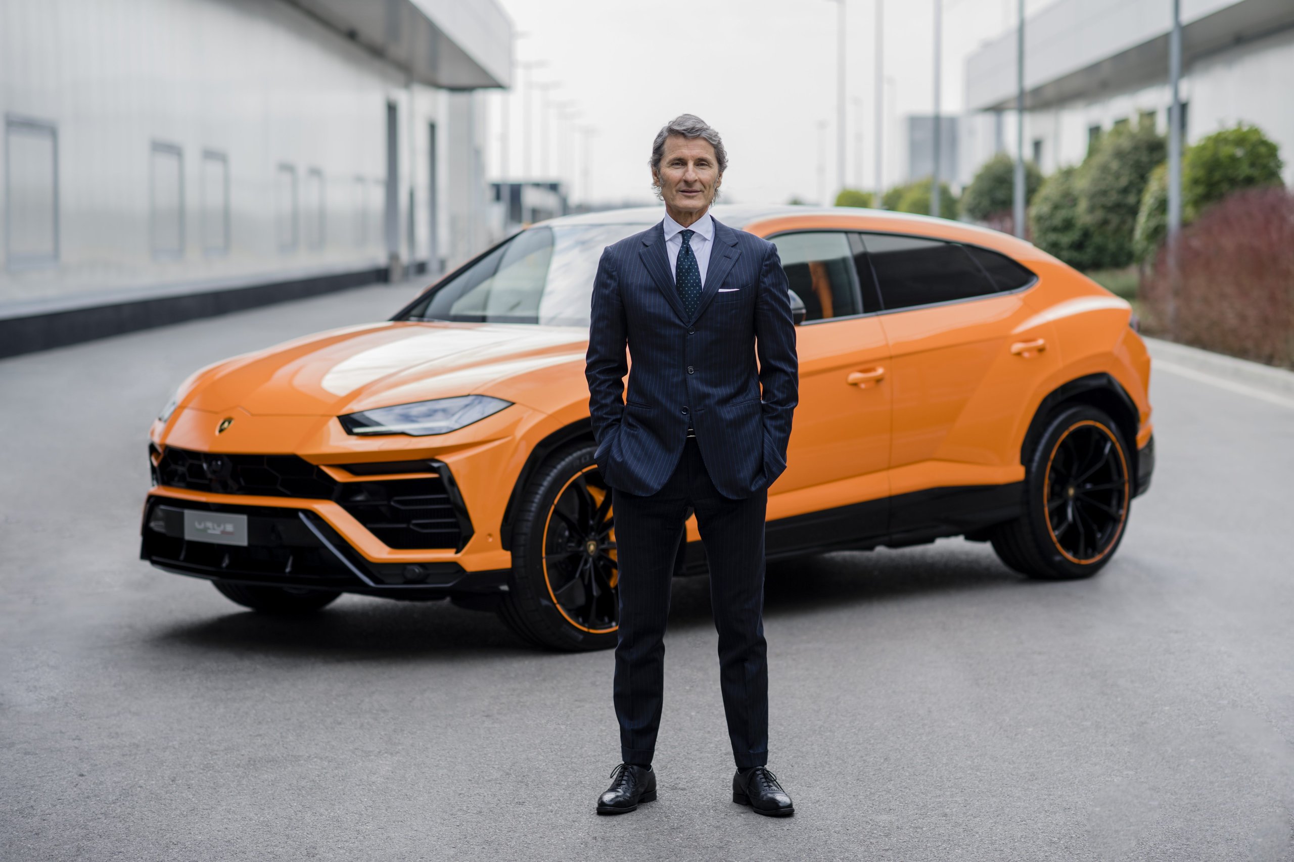 Lamborghini'S Q1 2022 Proves The Power Of Saying No: €178 Million In Profit By Selling Less Than The Market Wants 3 Stephan winkelmann standing in front of an orange lamborghini urus at a lamborghini facility