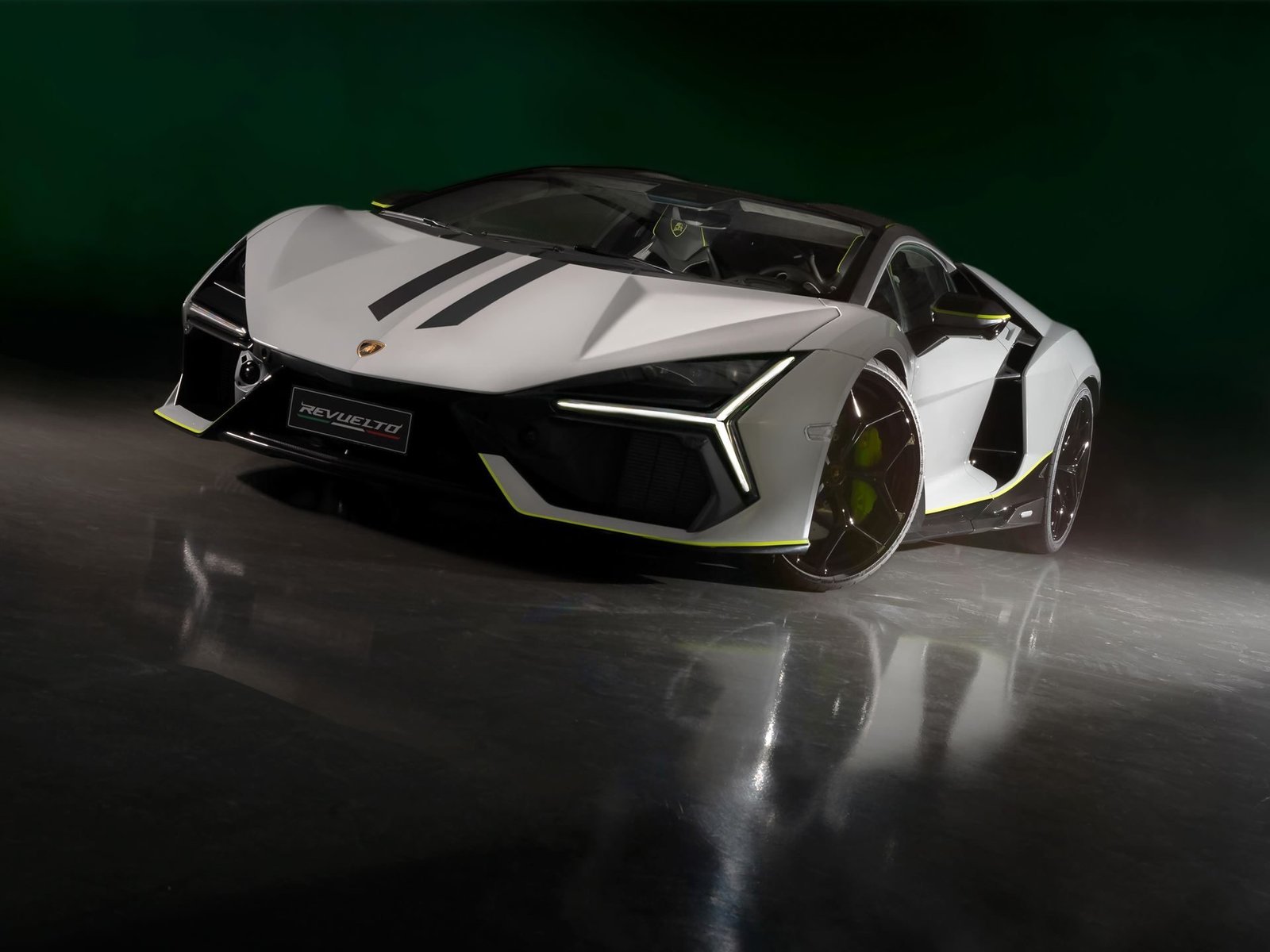 Front three-quarter view of the bespoke Lamborghini Revuelto Ad Personam Arena 2024 in Grigio Hati with Verde Scandal accents and black racing stripes