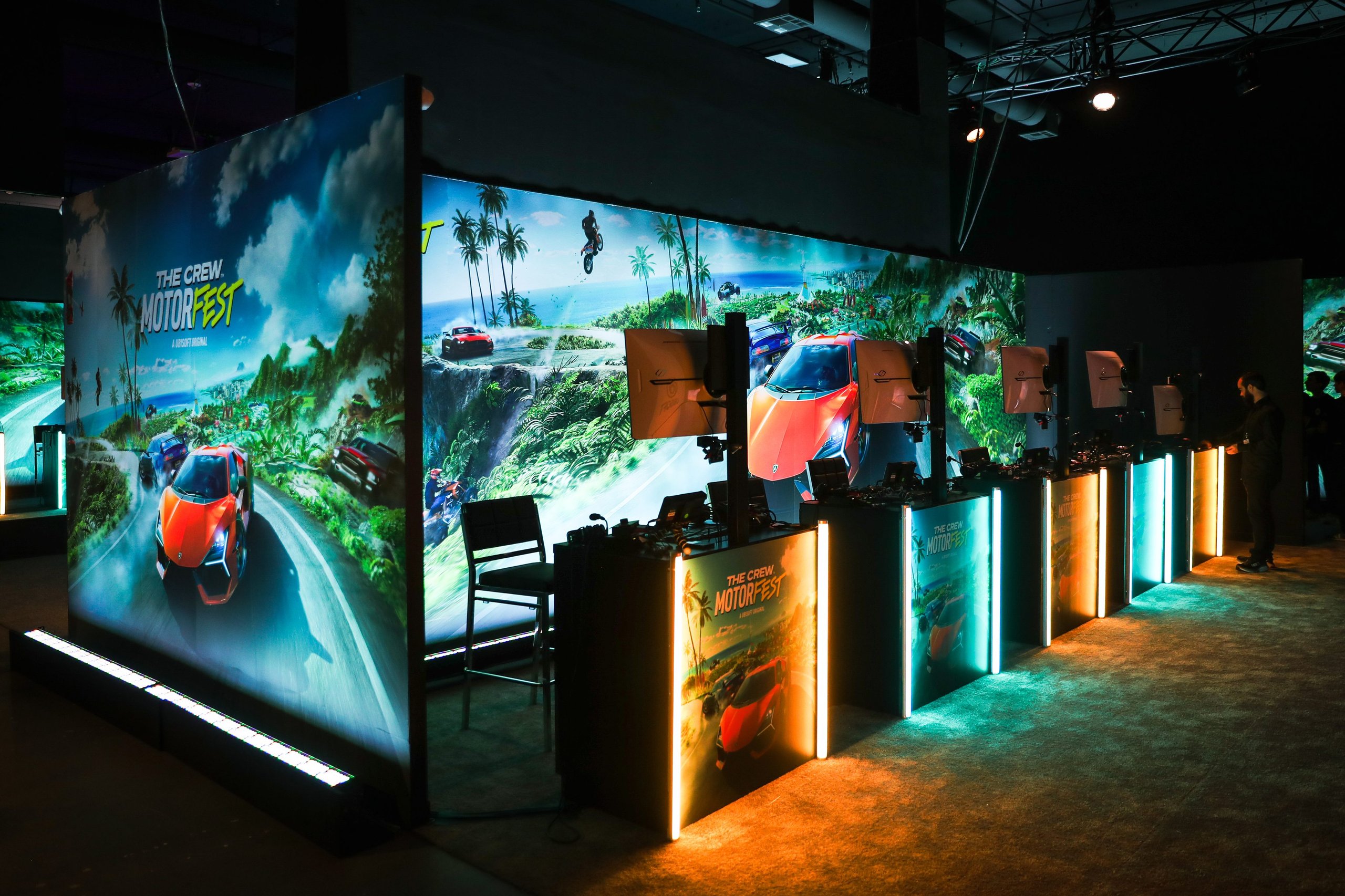 How The Revuelto Became A Cover Star: Lamborghini'S Calculated Bet On Gaming As A Digital Showroom 3 The crew motorfest gaming event booth with multiple screens displaying lamborghini revuelto gameplay under neon lights