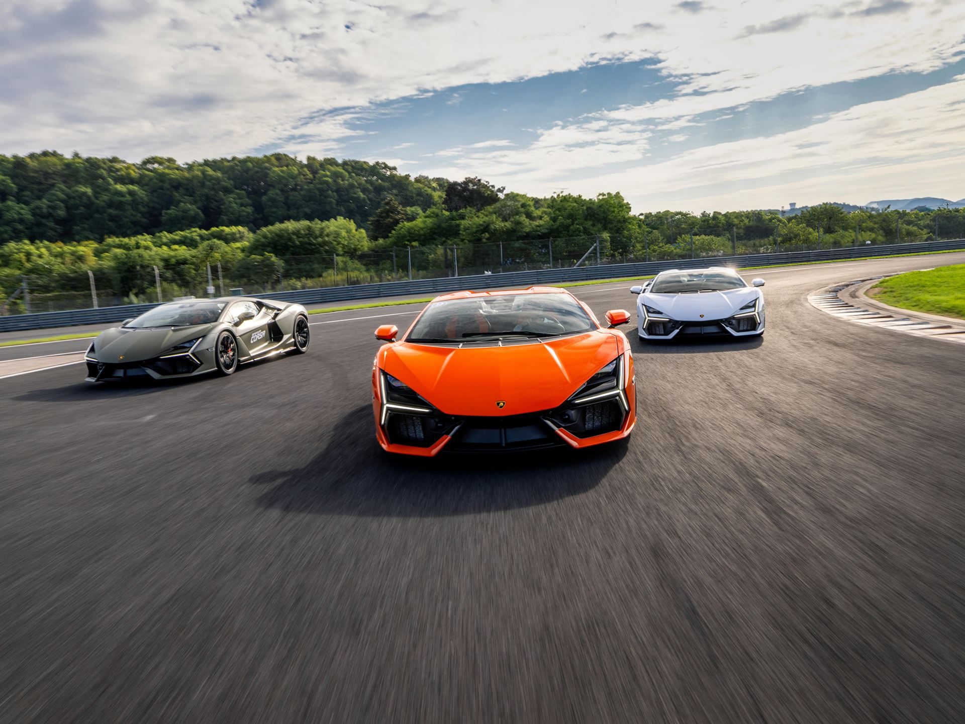 Lamborghini Brought The Revuelto To A Chinese Racetrack To Prove Its V12 Hybrid Belongs There 3 Three lamborghini revueltos in orange, olive green, and white driving in formation on zhejiang international circuit
