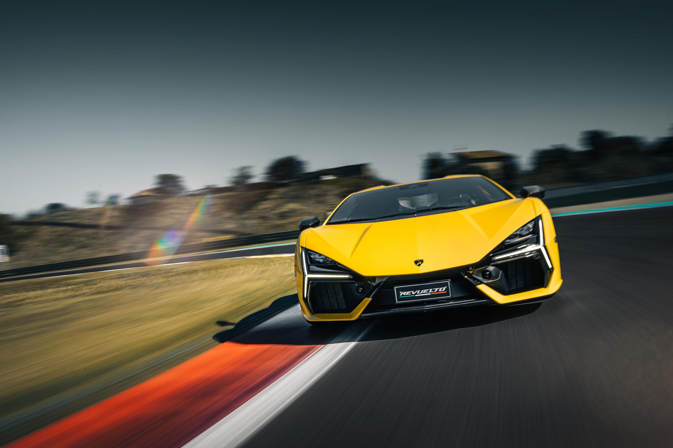 Lamborghini Sent The Revuelto Across Italy To Prove A 1,001 Hp Hybrid Can Still Be A Proper V12 Flagship 11 Yellow lamborghini revuelto speeding around a race track corner with motion blur