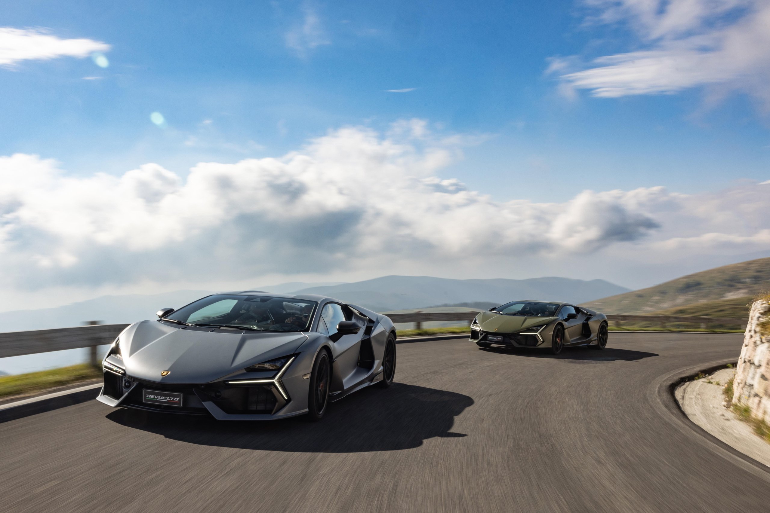 Lamborghini Sent The Revuelto Across Italy To Prove A 1,001 Hp Hybrid Can Still Be A Proper V12 Flagship 15 Two lamborghini revueltos in grey and olive green driving on a winding italian mountain road