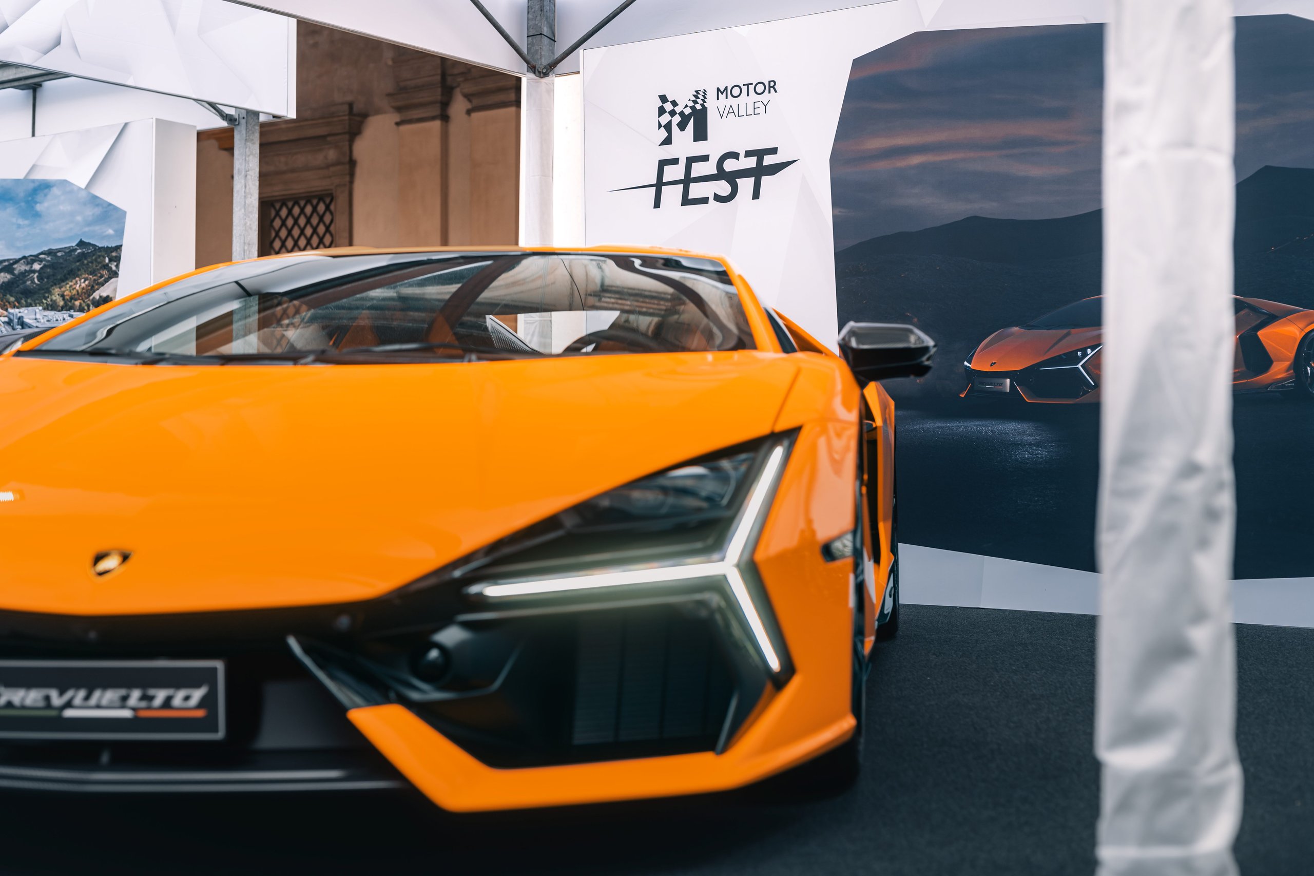 Motor Valley Fest 2023 Was Lamborghini'S First Public Statement That The Revuelto Era Had Arrived 7 Close-up low-angle shot of the front of an orange lamborghini revuelto showing y-shaped drls and hexagonal grille pattern at motor valley fest 2023