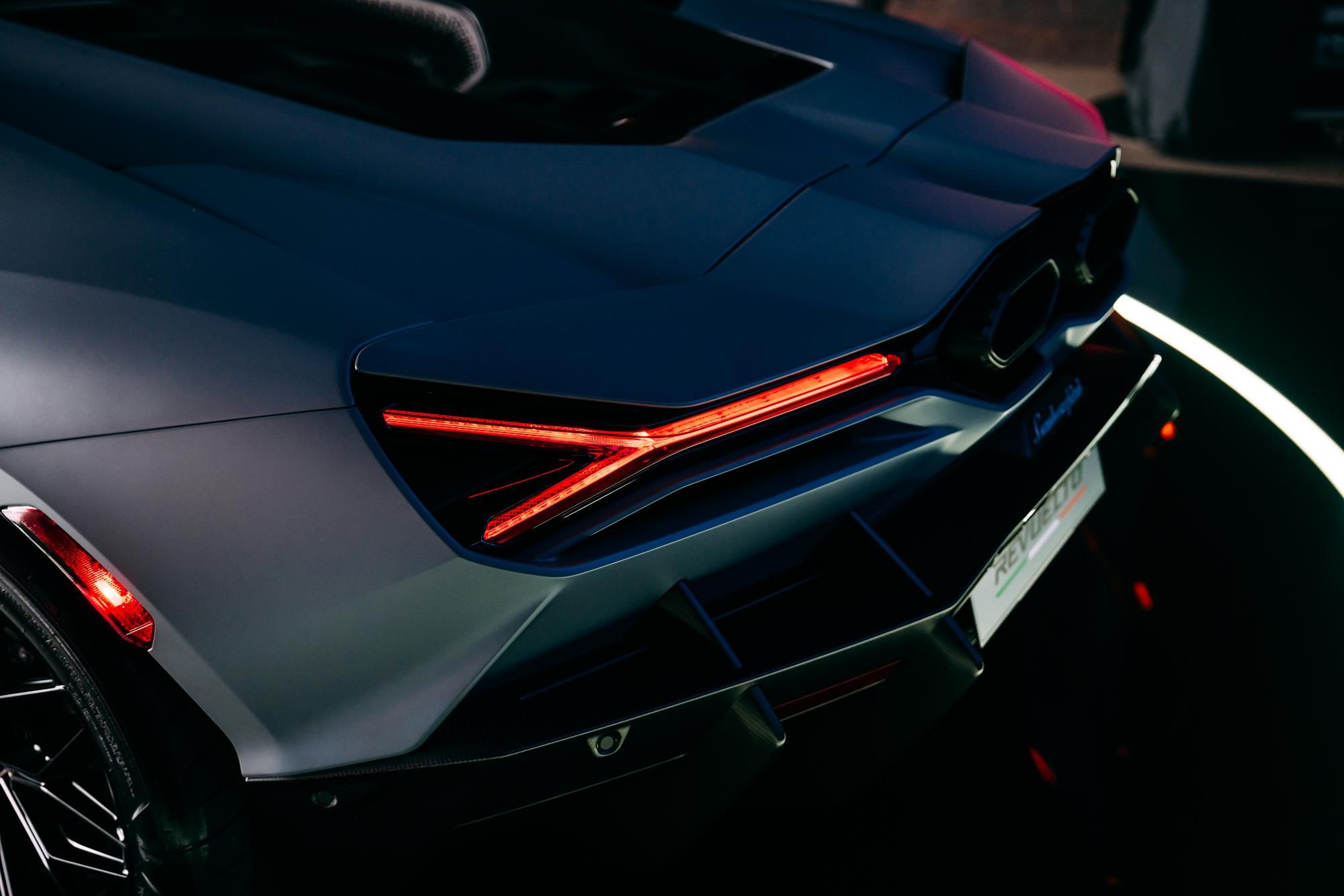 The Lamborghini Revuelto Is The V12 Hybrid That Replaced The Mighty Aventador 7 Rear view of a white lamborghini revuelto showing y-shaped taillights, hexagonal exhaust outlets, and rear diffuser