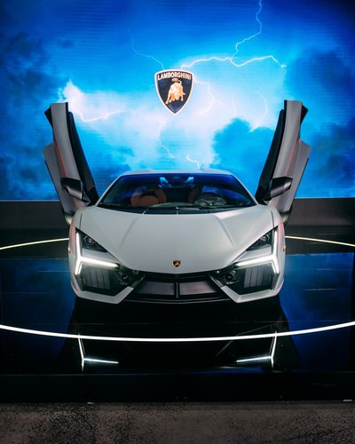 White lamborghini revuelto with scissor doors open on stage at the melbourne oceania debut event