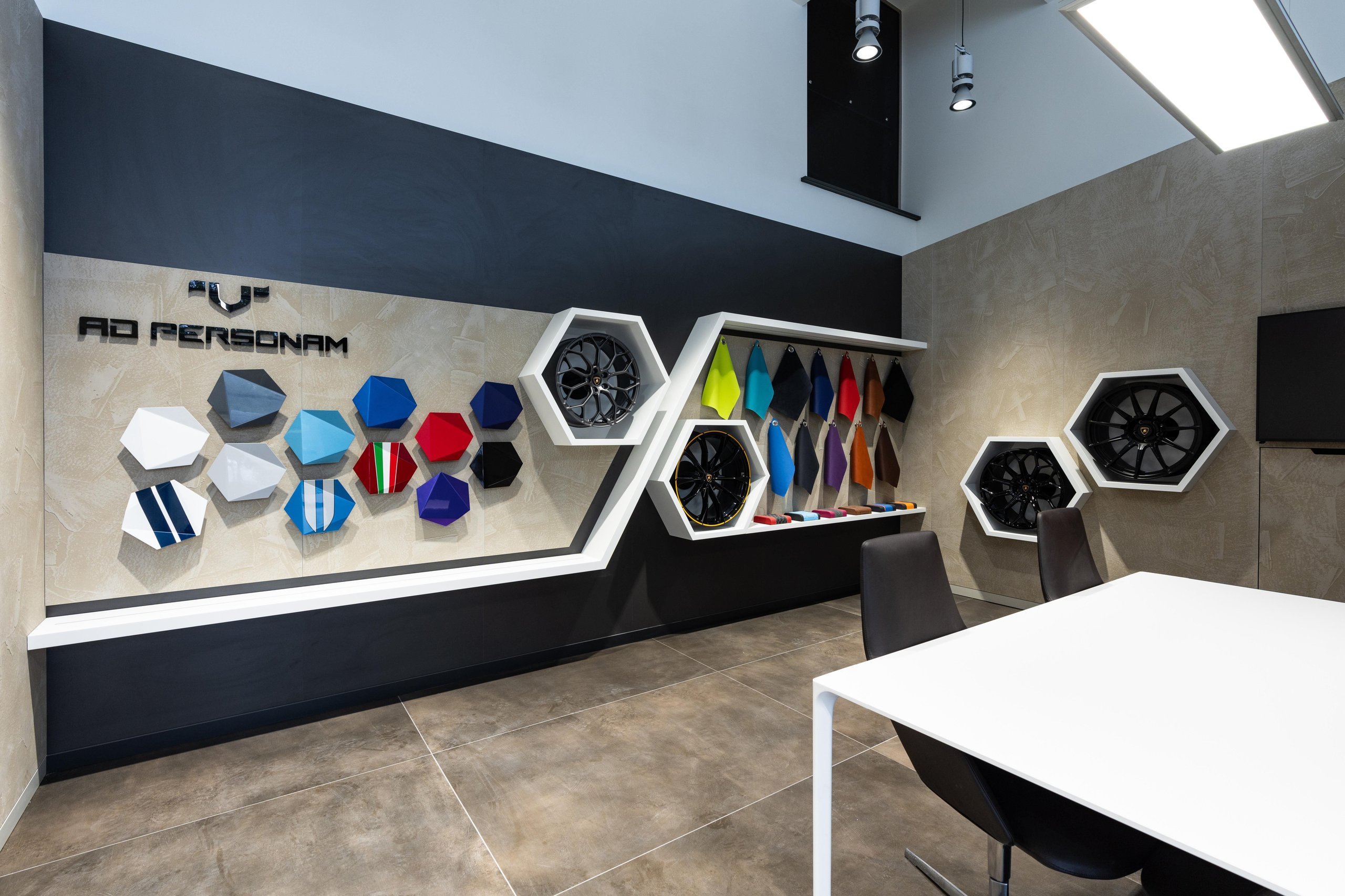 Lamborghini Riga: Why The Brand'S First Latvian Showroom Doubles As A Hybrid-Era Statement 9 The ad personam customization area inside the lamborghini riga showroom featuring hexagonal displays of paint samples, wheel options, and material swatches