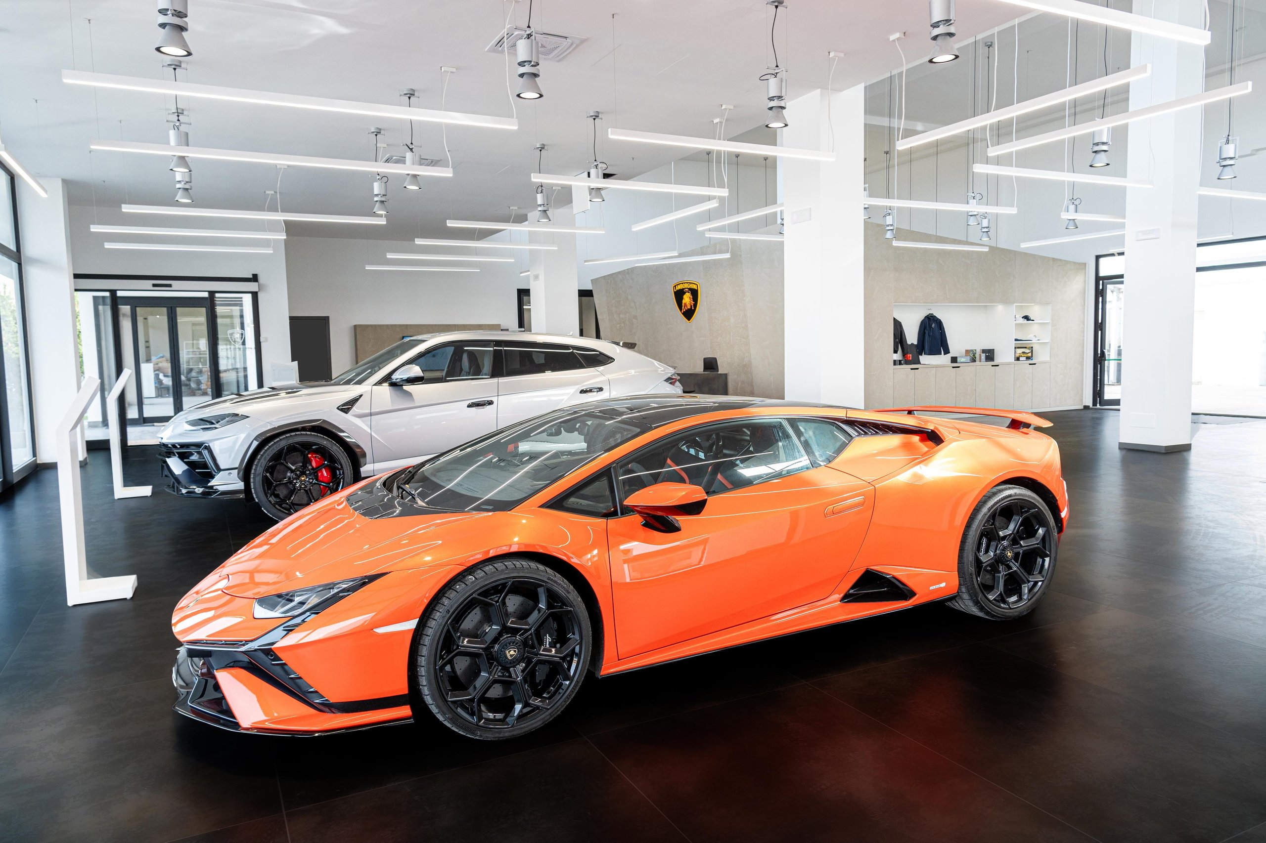 Lamborghini'S New Rome Flagship Pairs A Miura With The Revuelto To Sell Its Electrified Future 11 Orange lamborghini huracán tecnica and silver urus performante displayed side by side in the rome showroom