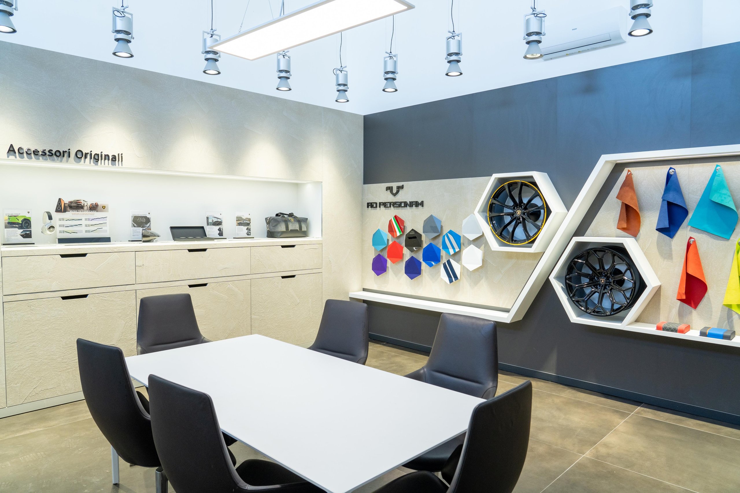 Lamborghini'S New Rome Flagship Pairs A Miura With The Revuelto To Sell Its Electrified Future 5 Interior of the lamborghini rome ad personam studio showing a consultation table with leather swatches and alloy wheel samples on the wall