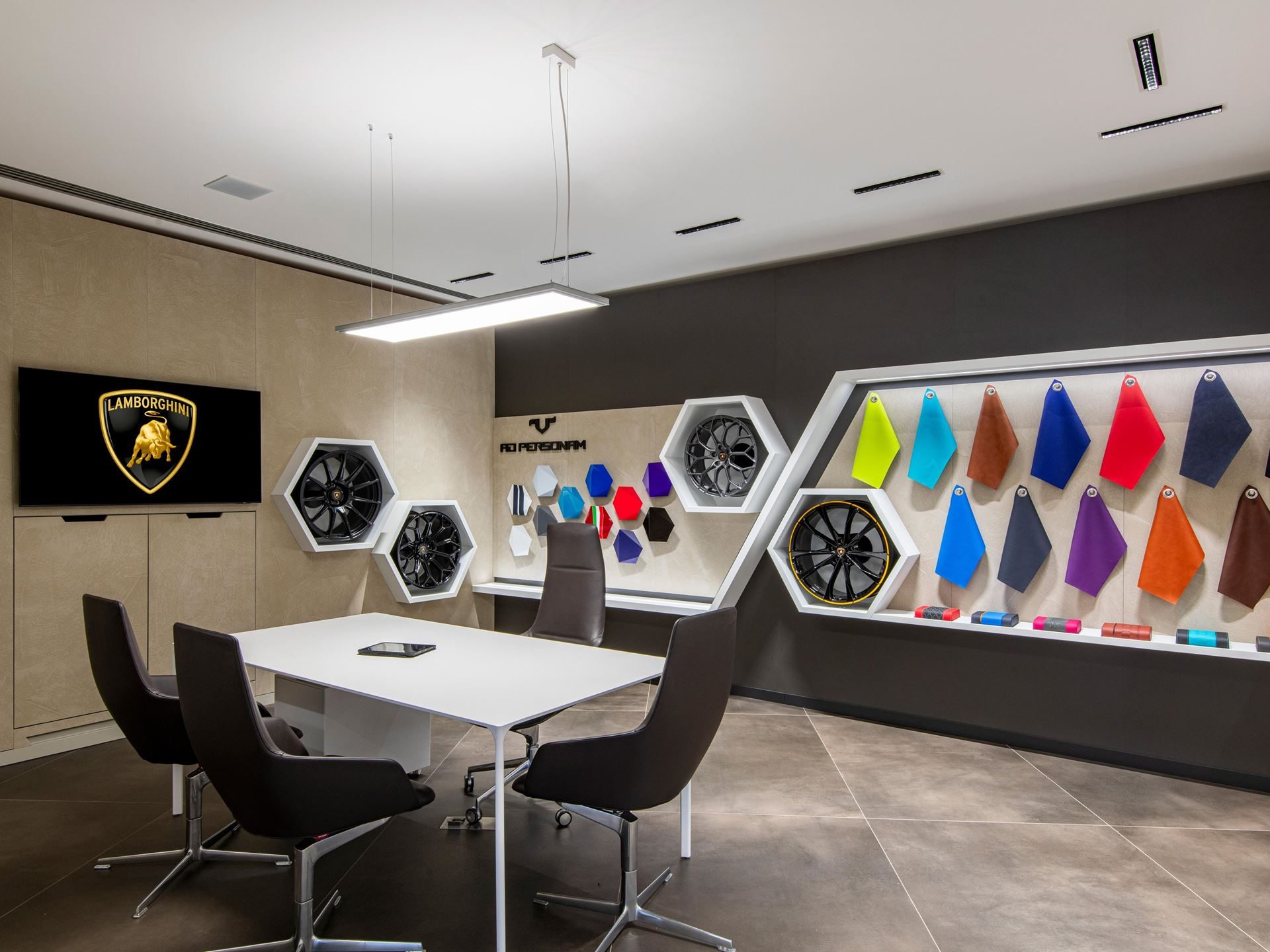Lamborghini Opens Its First São Paulo Showroom With The Sterrato'S South American Debut, Laying The Ground For A Hybrid Future 7 Interior of the lamborghini ad personam customization studio showing material samples, wheel displays, and consultation table