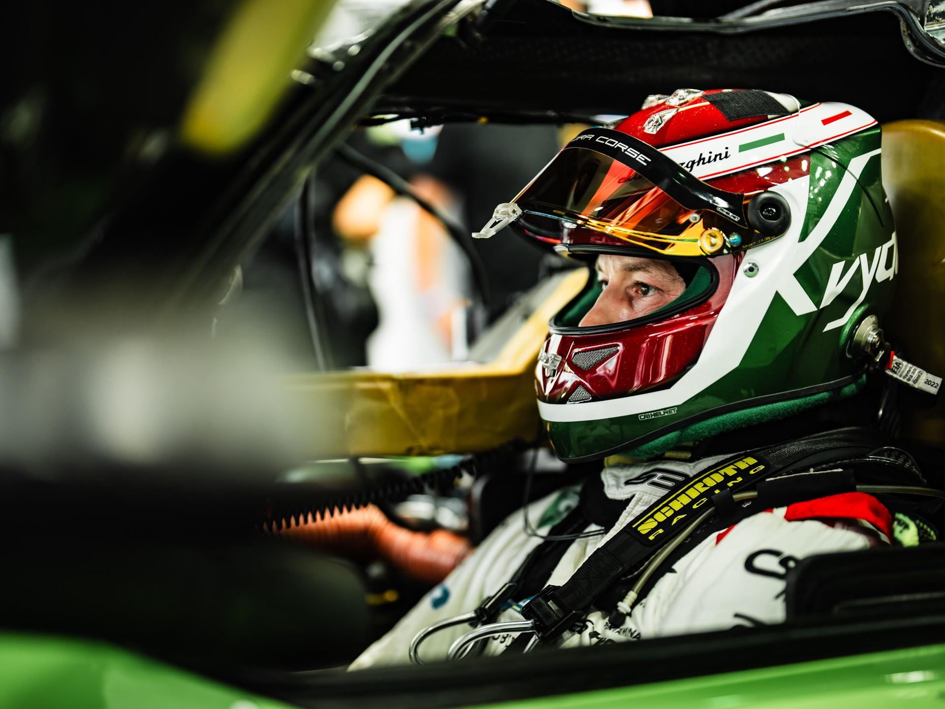 Lamborghini Sc63 Earns First Hyperpole At Fuji, Then A Drivetrain Failure Ends The Story Early 5 Race car driver wearing a helmet with italian flag colors seated in the cockpit of the green lamborghini sc63
