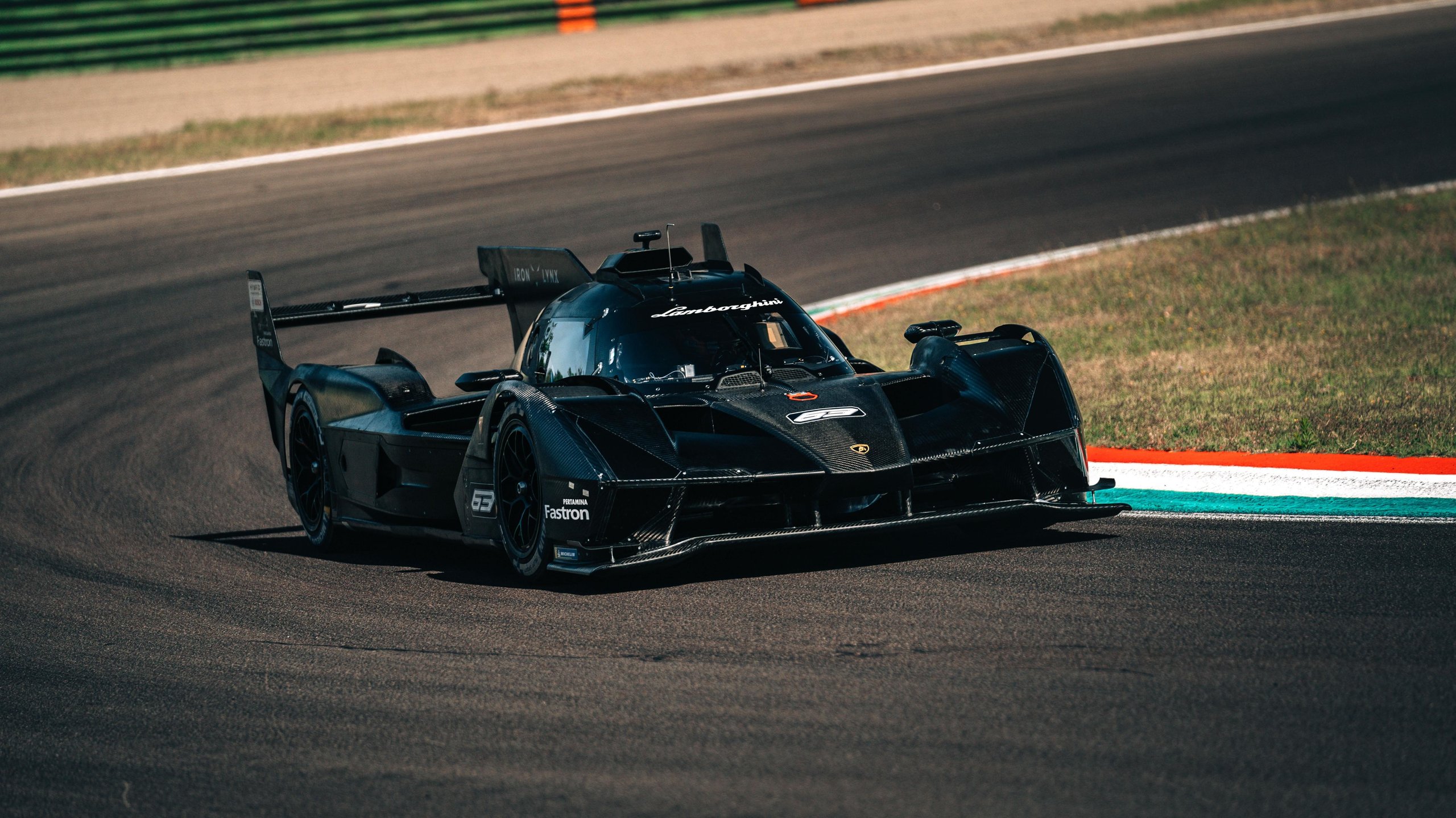 The Sc63'S First 1,500 Kilometers At Imola Promised A New Era. Then Reality Arrived. 3 Lamborghini sc63 lmdh prototype in black livery carving through a turn at imola during its maiden on-track test