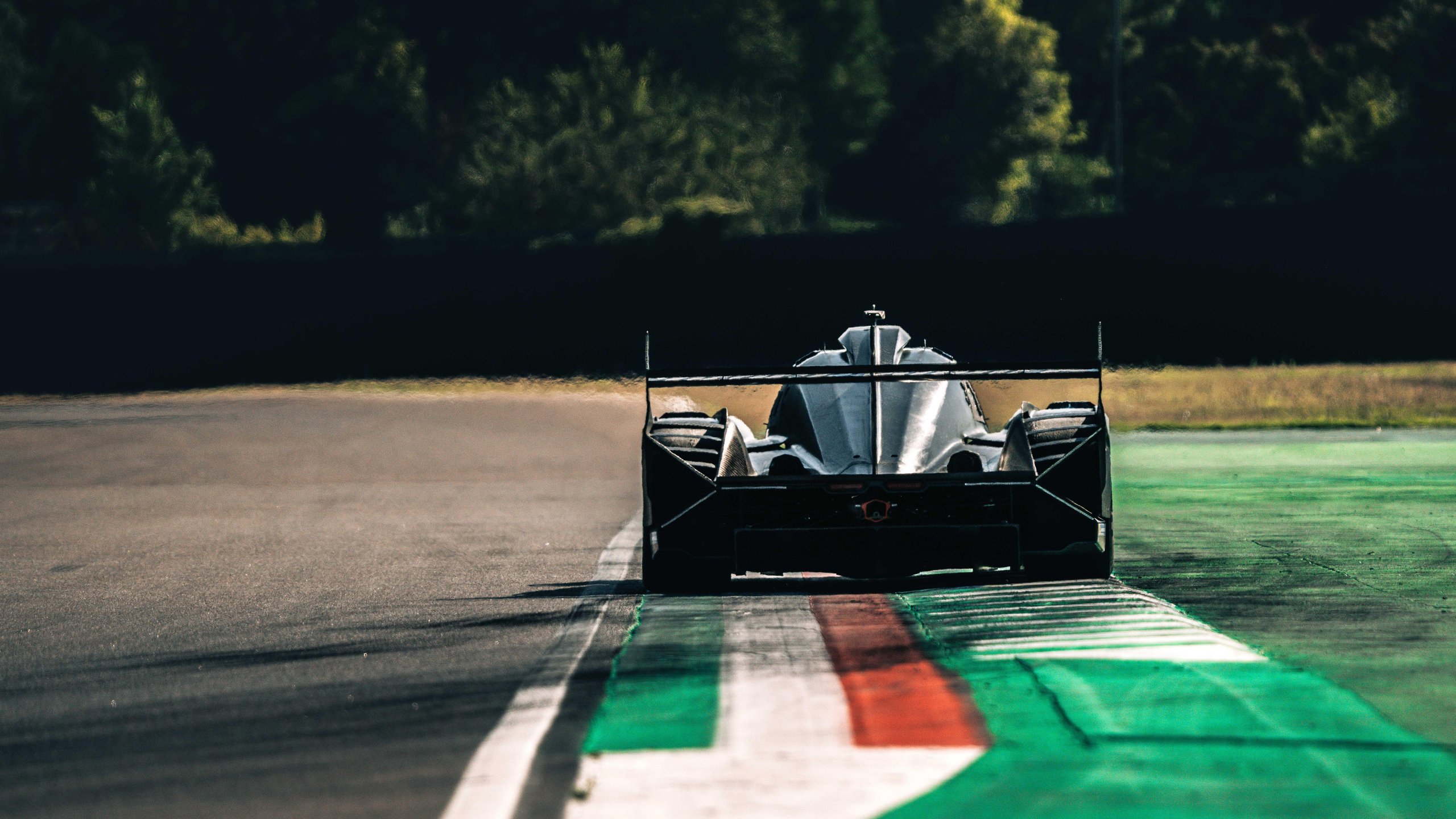 The Sc63'S First 1,500 Kilometers At Imola Promised A New Era. Then Reality Arrived. 7 Rear view of the lamborghini sc63 lmdh prototype driving away on the imola circuit under bright skies