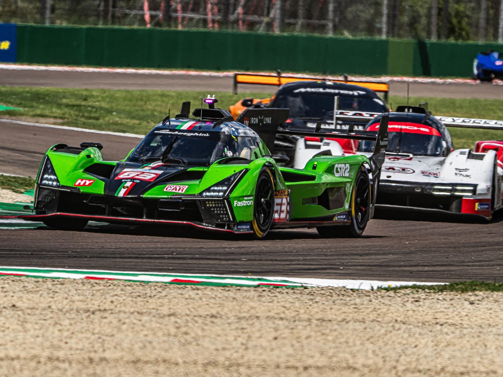 Lamborghini Sc63 Heads To Le Mans Carrying Points, Progress, And One Cracked Axle 7 Lamborghini sc63 leading other competitors on a bright racetrack