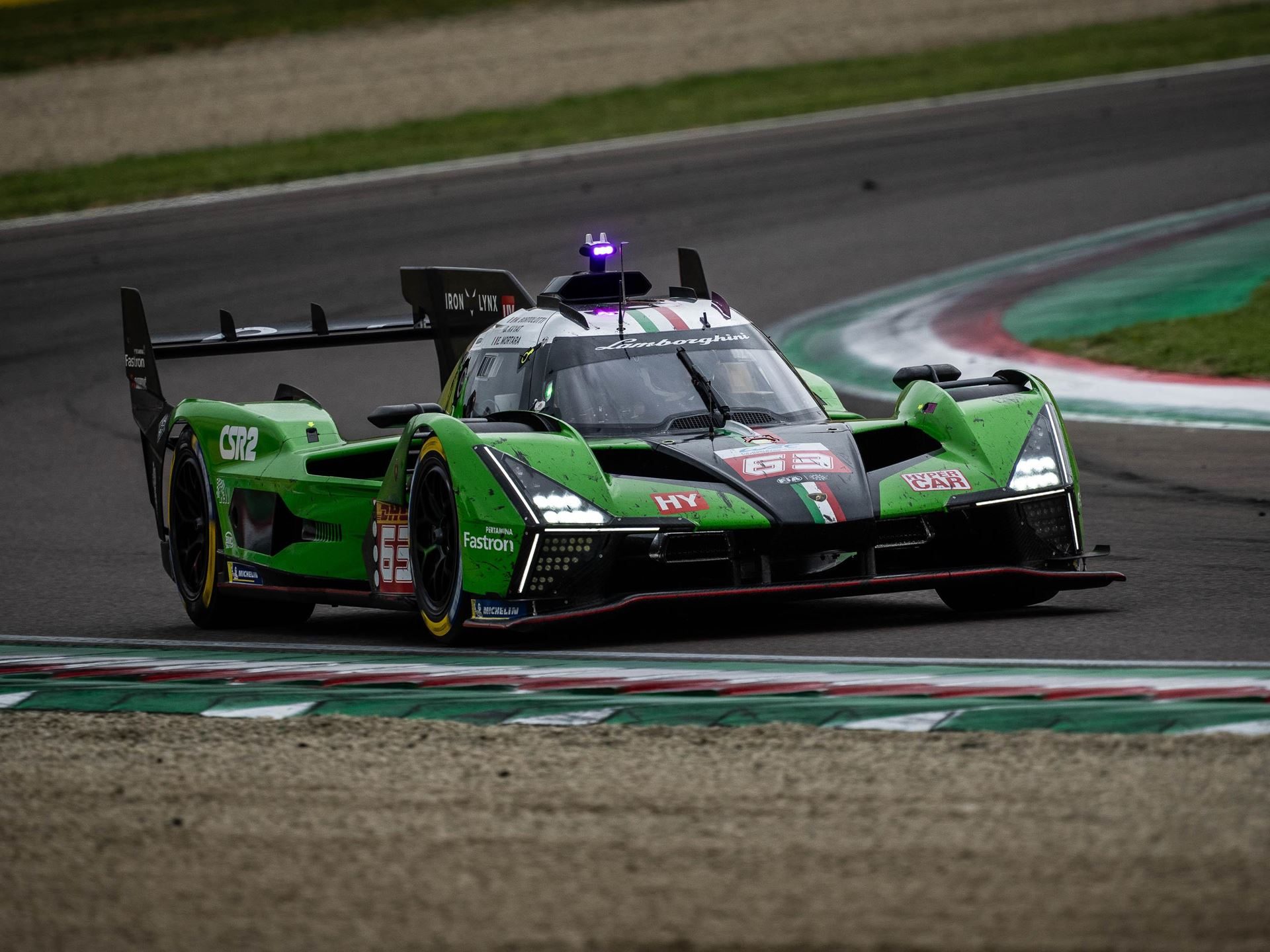 Lamborghini Sc63 Heads To Le Mans Carrying Points, Progress, And One Cracked Axle 11 Lamborghini sc63 in green and black livery with italian flag stripes cornering on a race track