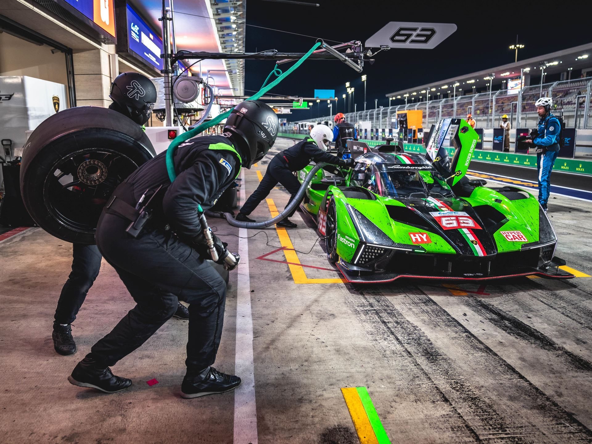 Lamborghini Sc63 Heads To Le Mans Carrying Points, Progress, And One Cracked Axle 5 Lamborghini sc63 undergoing a night pit stop with crew changing tires and refueling