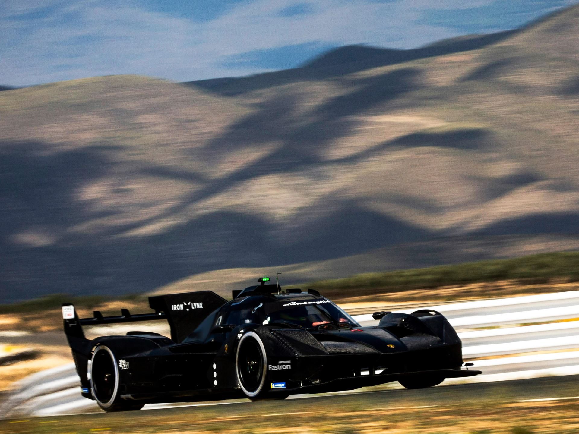 The Sc63 Lmdh Looked Like Lamborghini'S Future. Then The Future Changed. 3 Lamborghini sc63 lmdh prototype in iron lynx livery at speed on the almería circuit with blurred desert mountains in the background