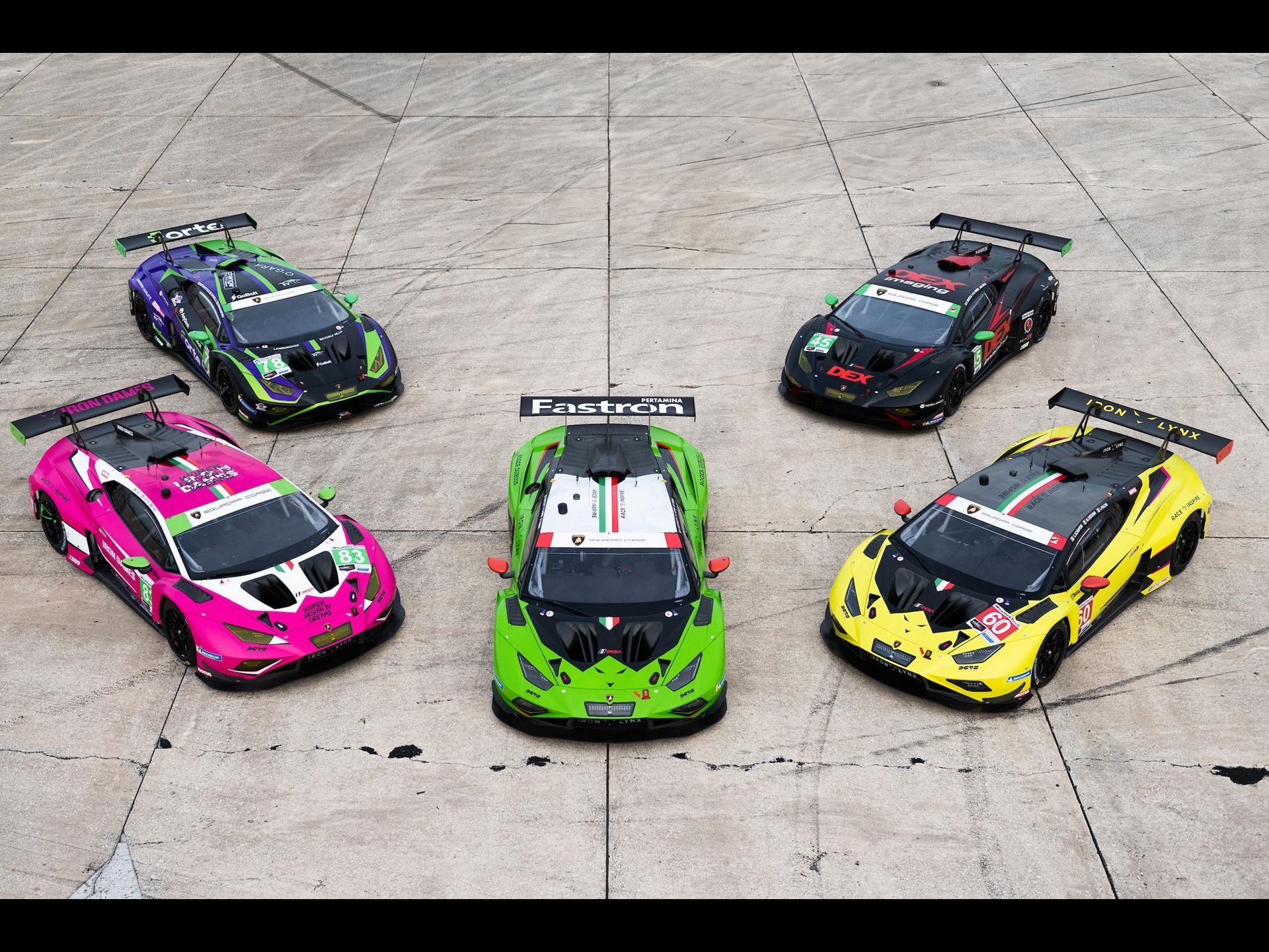 Lamborghini'S Sc63 Lmdh Arrives At Sebring To Learn, Not To Win 5 Aerial view of five lamborghini huracán gt3 evo2 race cars with distinct liveries parked on concrete