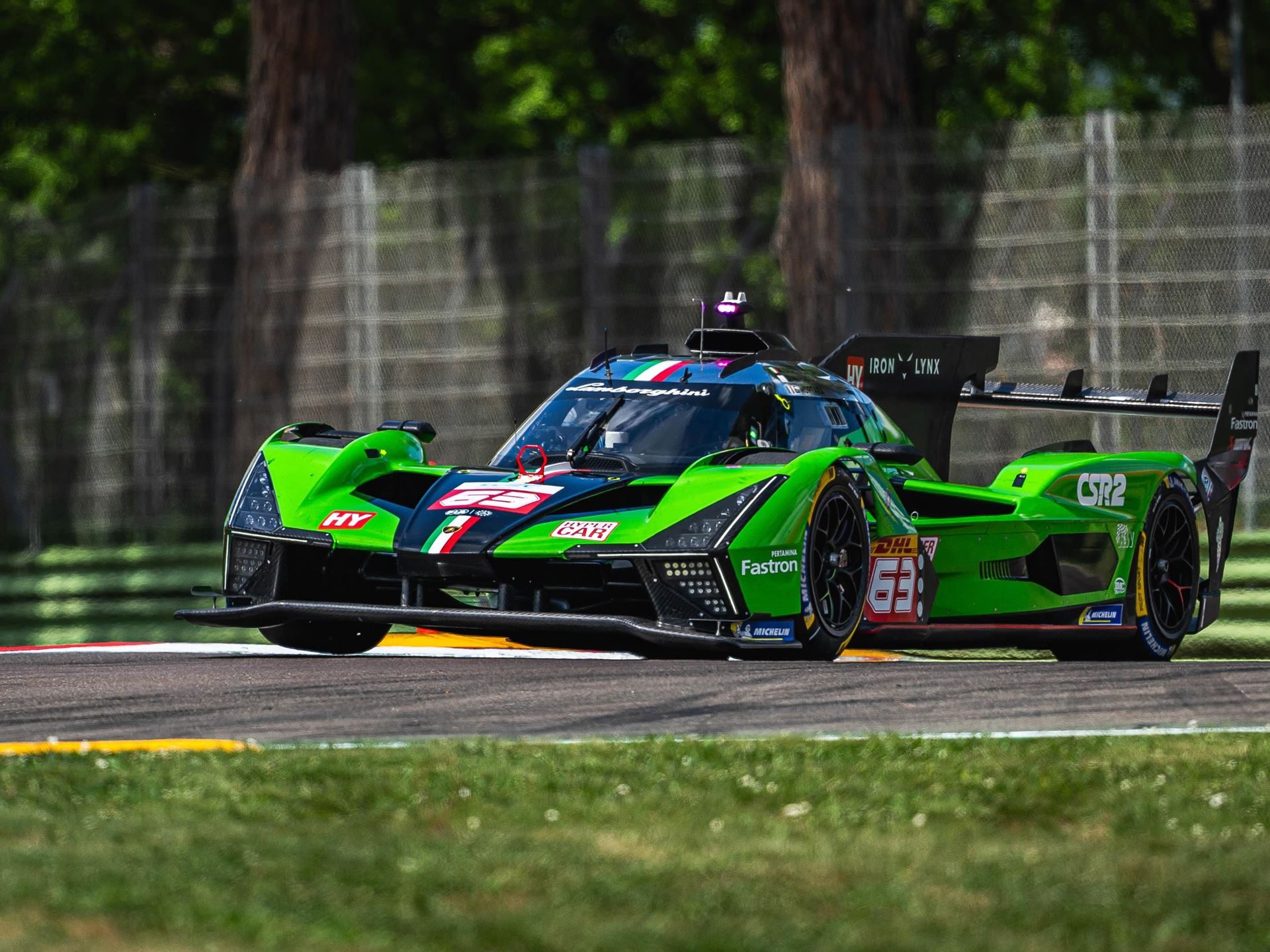 Lamborghini Sc63 Faces Its Final Exam At Spa Before Le Mans 3 Lamborghini sc63 navigating a turn on a sunny racetrack, showing aggressive front design and italian flag accents on the racing livery