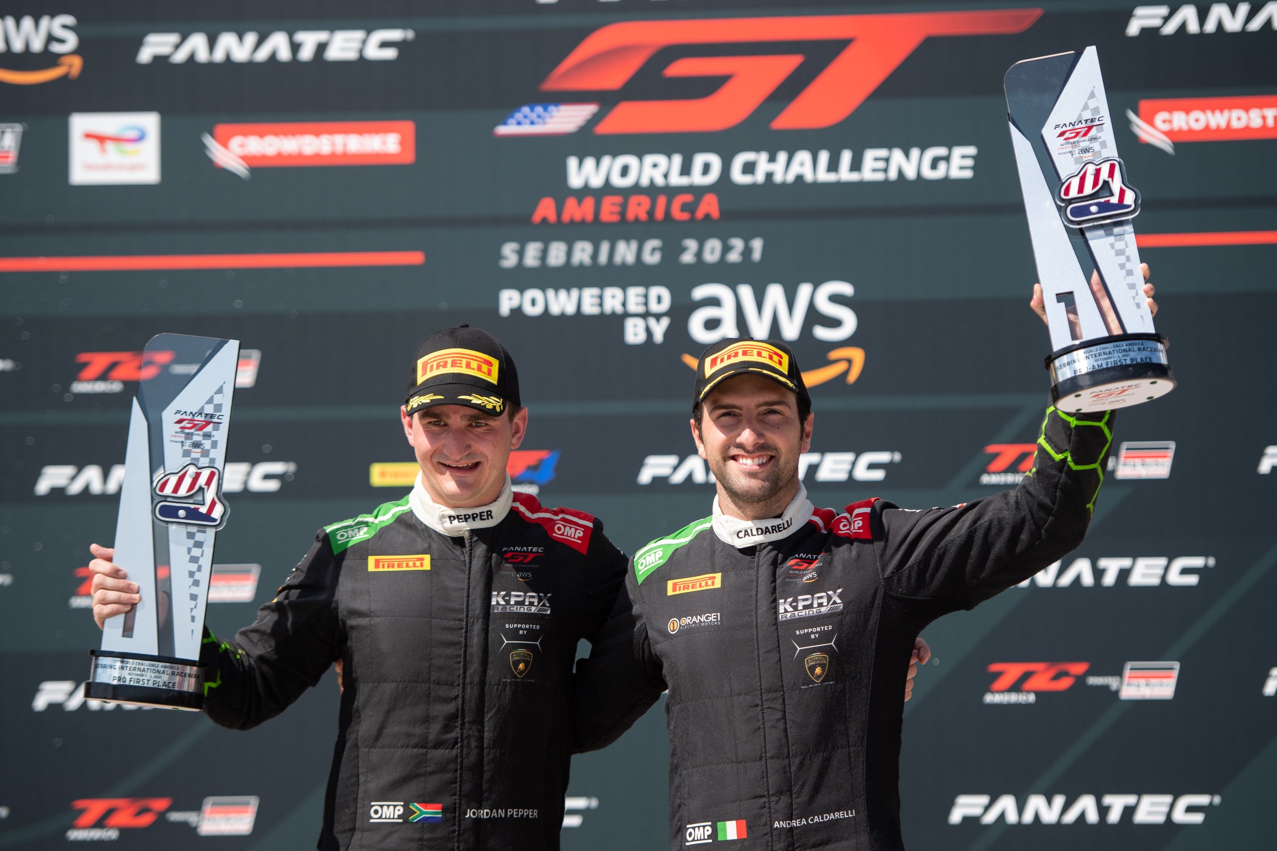 Seven Titles In One Season: What Squadra Corse'S 2021 Sweep Reveals About Lamborghini'S Racing Machine 3 Jordan pepper and andrea caldarelli celebrate on the podium with trophies at the gt world challenge america sebring 2021